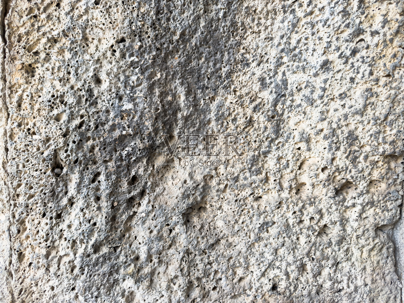 米色多孔表面背景的微距摄影照片摄影图片