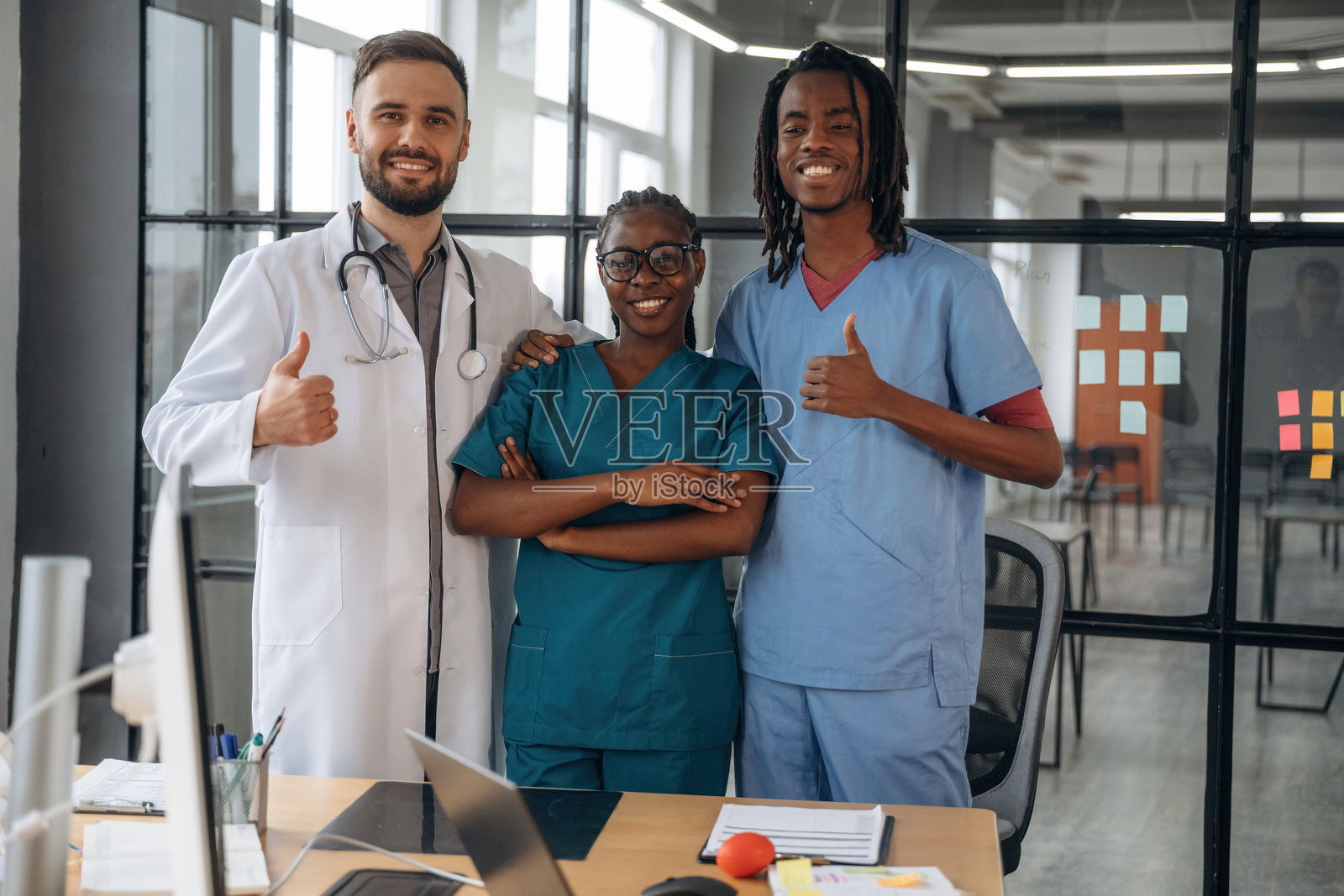 医生们在办公室里站着摆姿势。照片摄影图片