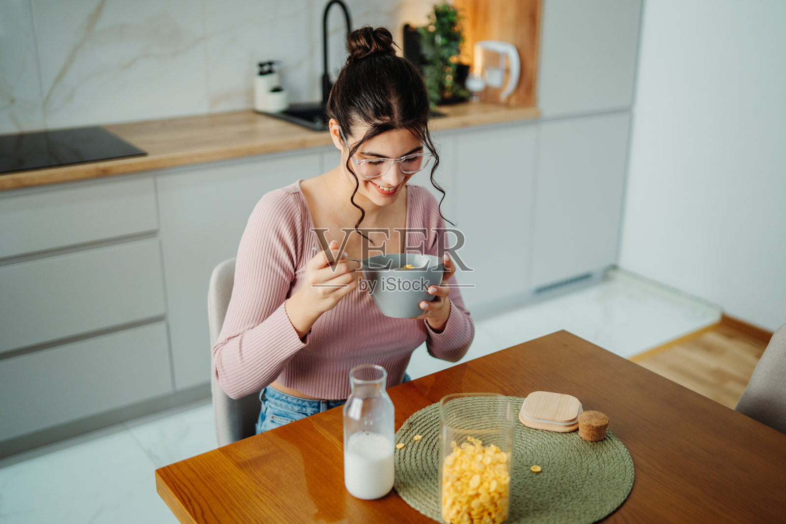 年轻的白人女性在家吃玉米片早餐照片摄影图片