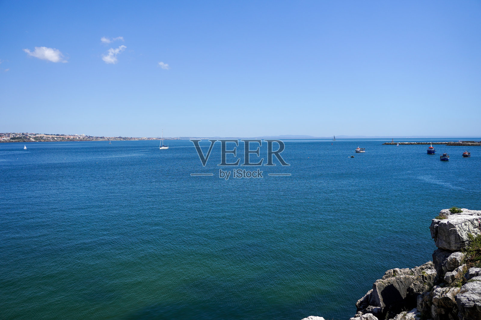 宁静的海洋景观，船只、帆船和阳光明媚的海岸悬崖照片摄影图片