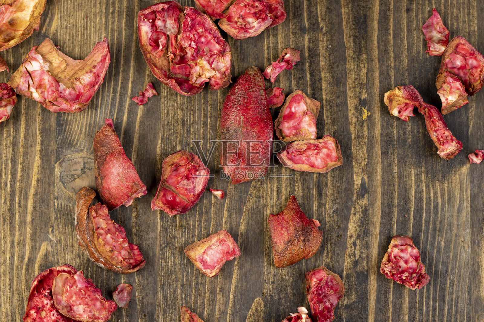 成熟石榴的果皮放在桌子上，甜美的红色石榴在厨房里照片摄影图片