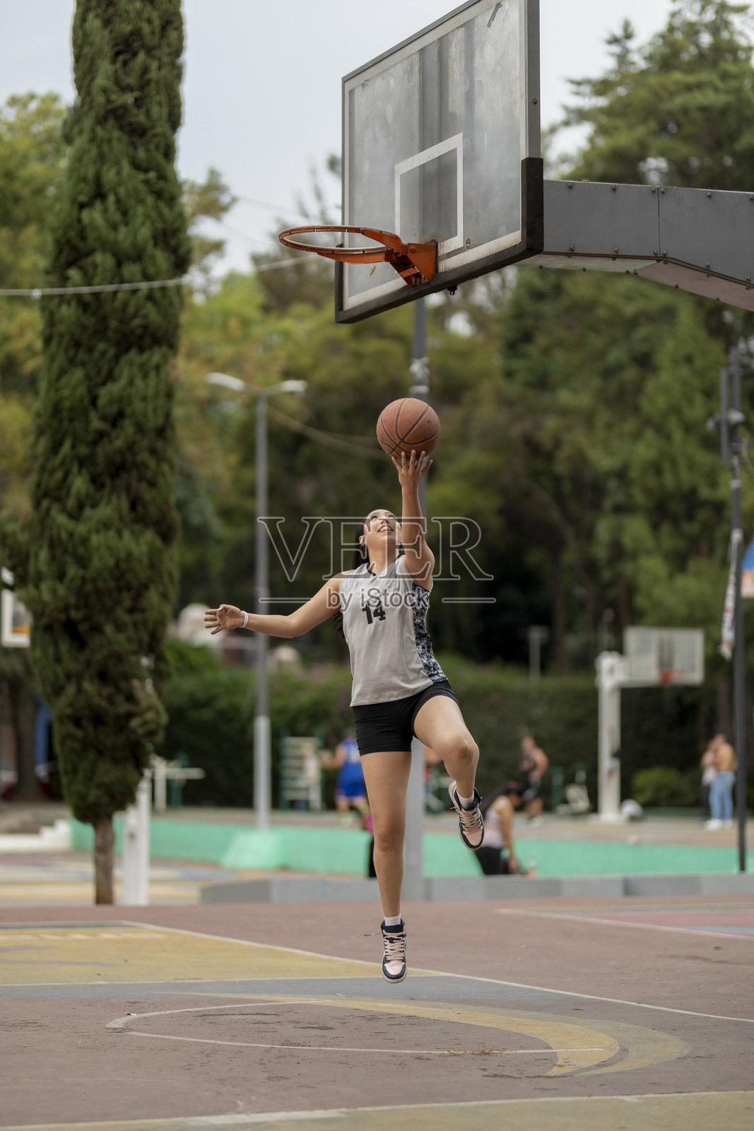 年轻女性篮球运动员在户外投篮照片摄影图片