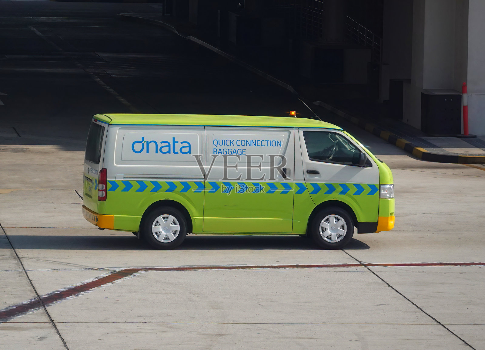 在阿联酋迪拜机场，dnata小型面包车提供快速行李连接服务。照片摄影图片