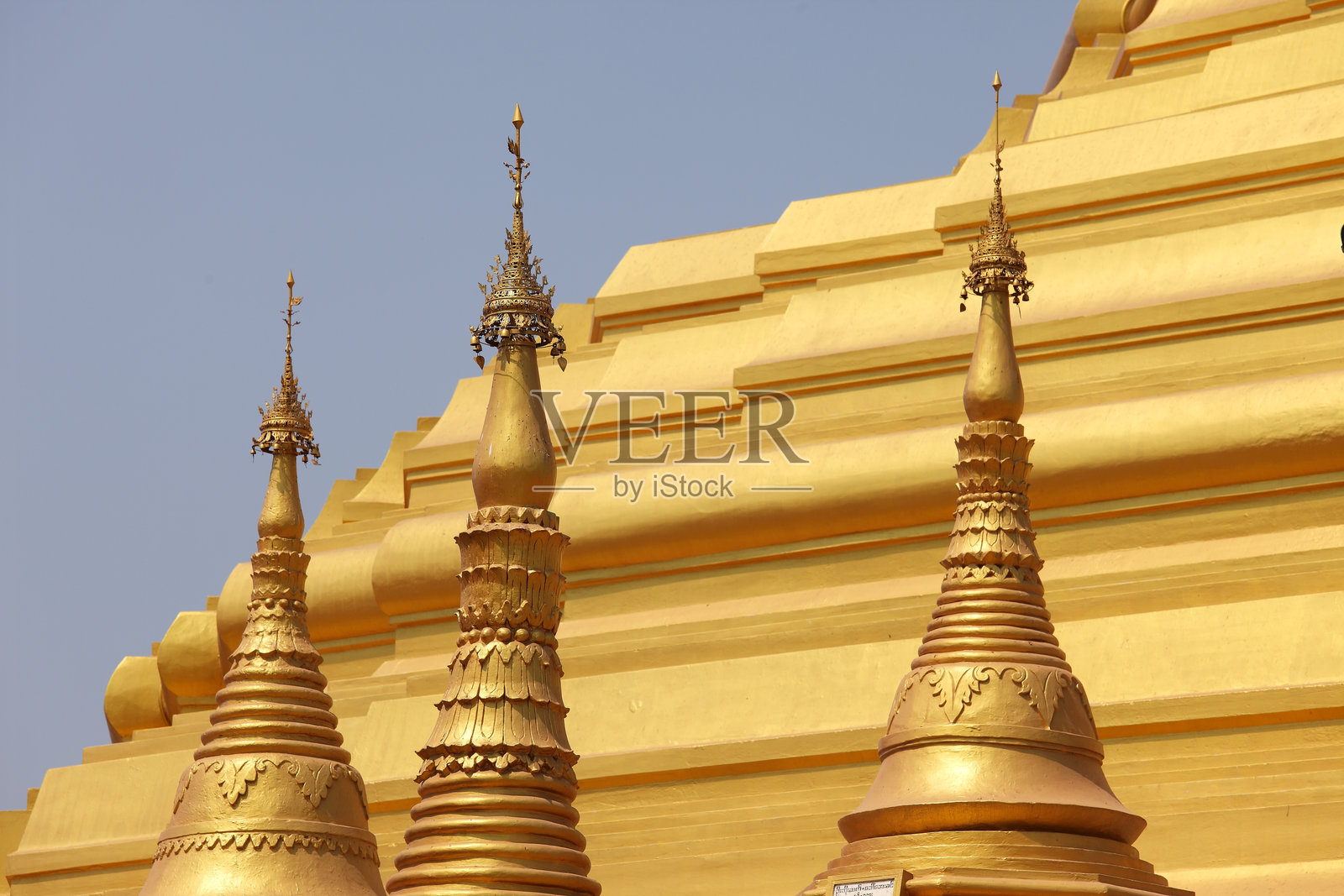 历史佛教寺庙群中金色佛塔与晴朗天空相映成趣照片摄影图片