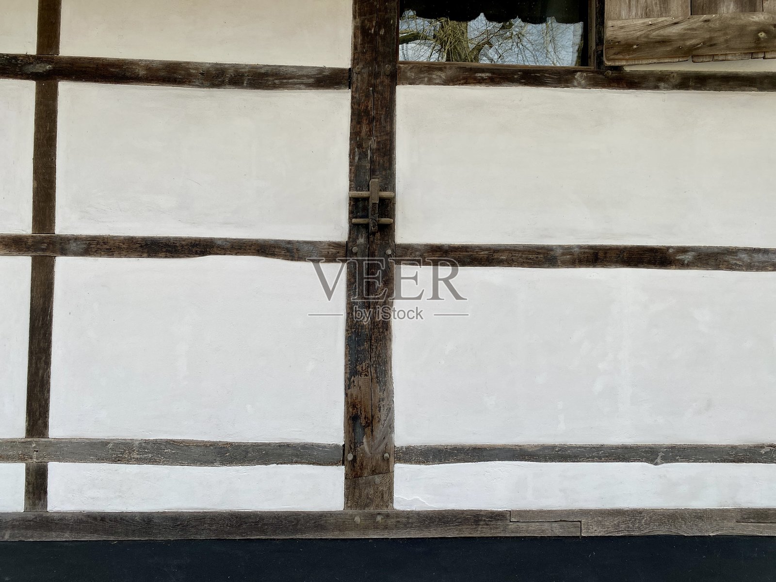 历史农舍中的半木框架的一部分。照片摄影图片