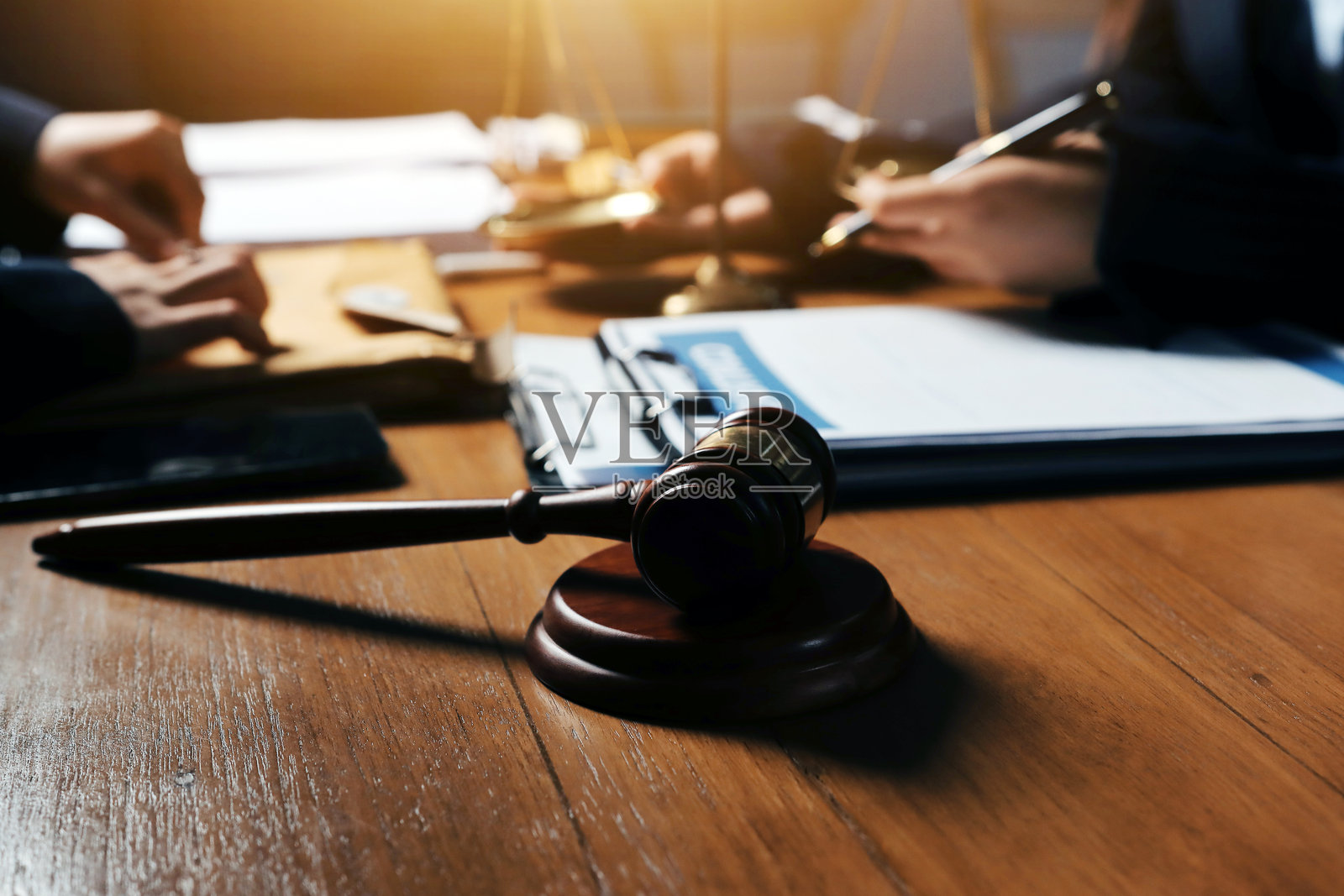 Attractive young lawyer in office Business woman and lawyers discussing contract papers with brass scale on wooden desk in office. Law, legal services, advice, Justice and real estate concept.照片摄影图片