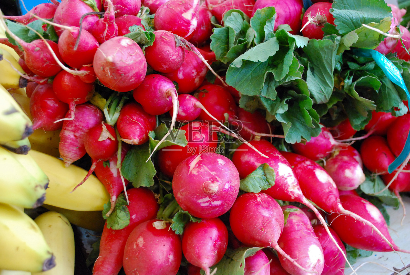 市场篮子里的萝卜和绿叶蔬菜照片摄影图片