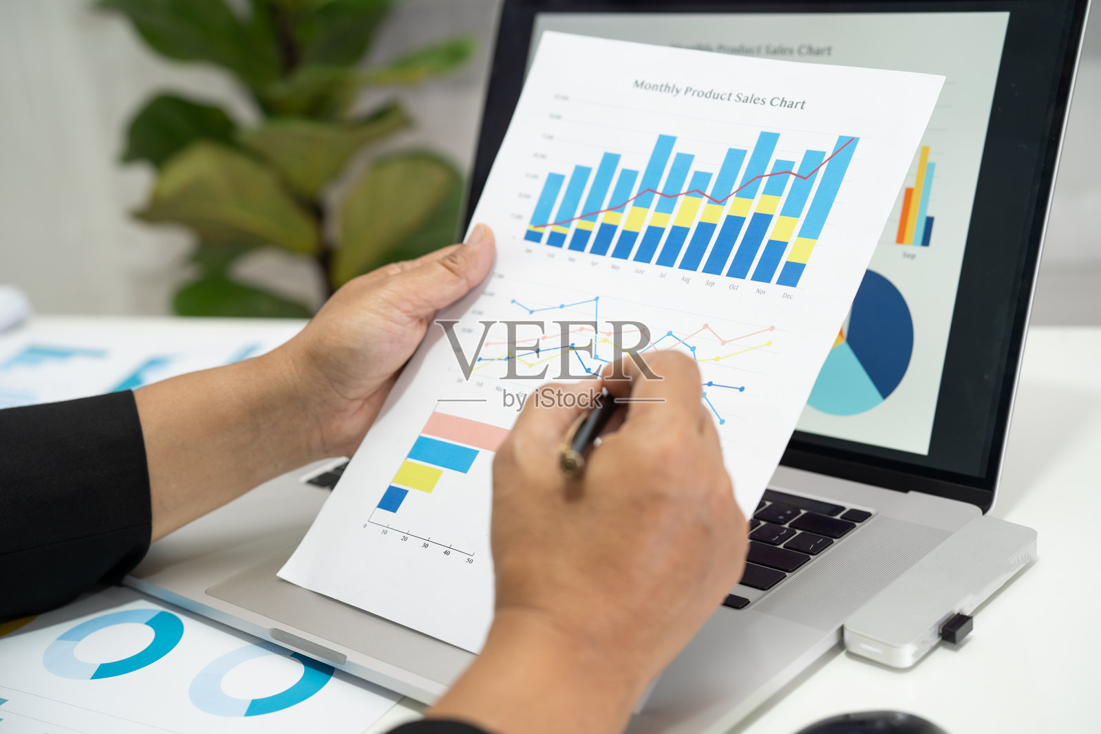 亚洲会计师在现代办公室工作，分析财务报告，进行项目会计，使用图表、图形和计算器，体现金融和商业概念。照片摄影图片