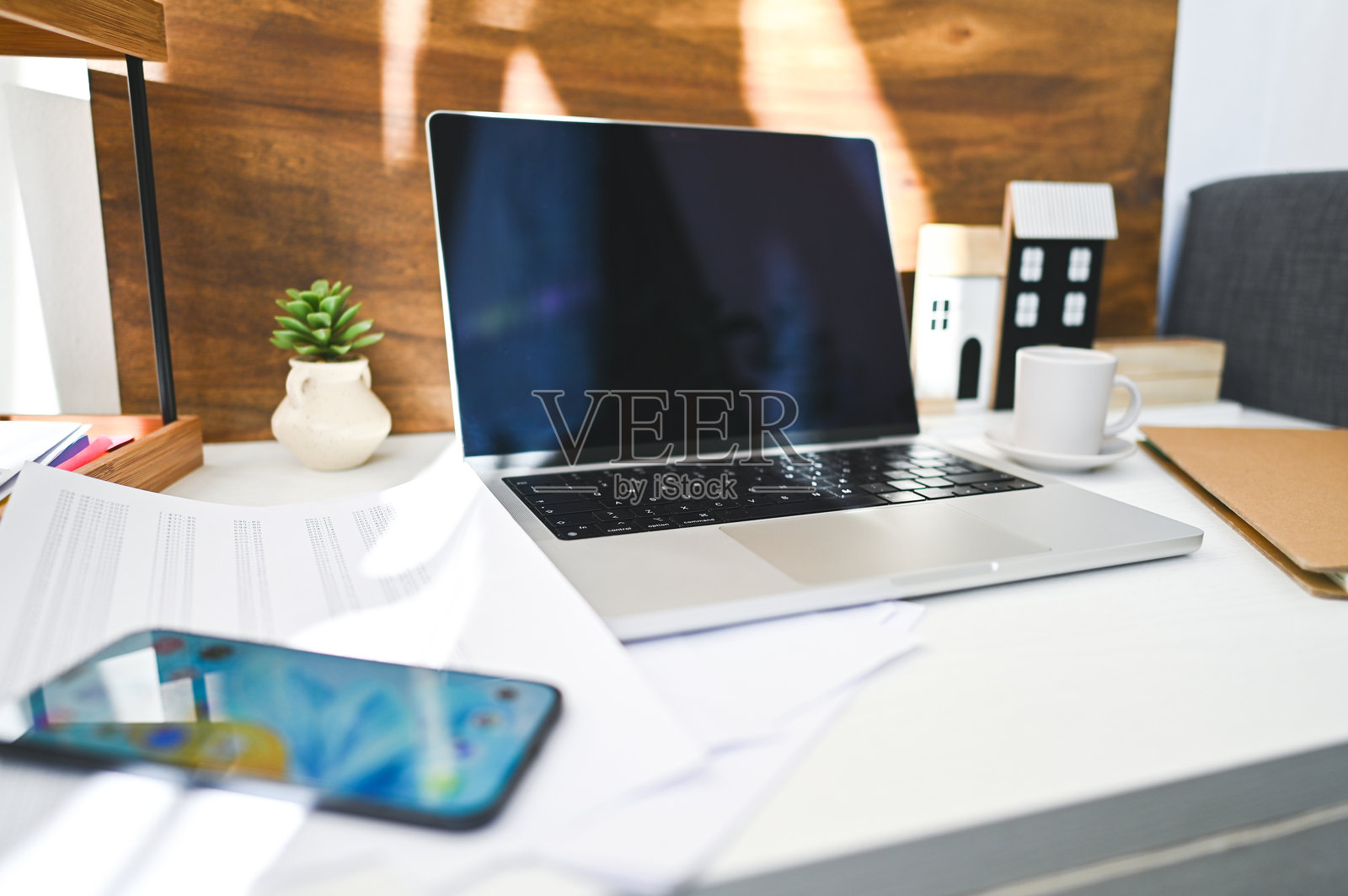 现代家居办公室设置，配有笔记本电脑、智能手机和文件照片摄影图片