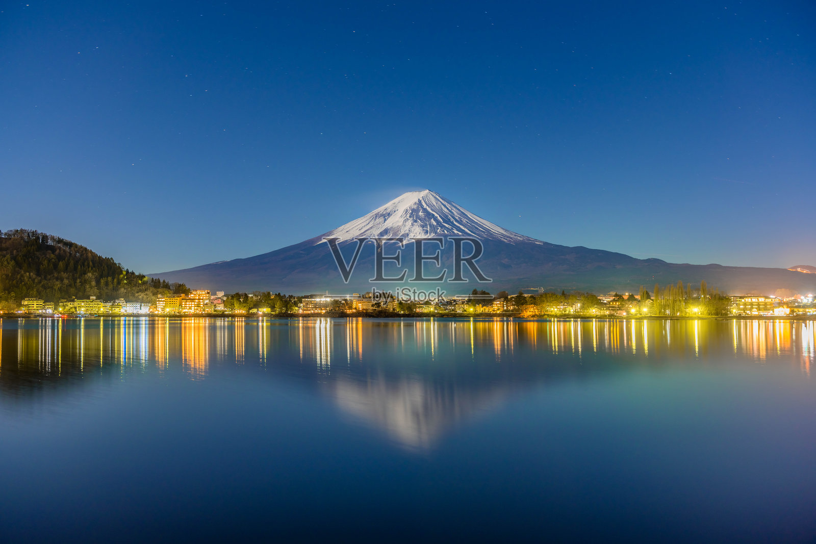 夜晚富士山倒映在河口湖中，湖边小镇灯火辉煌照片摄影图片