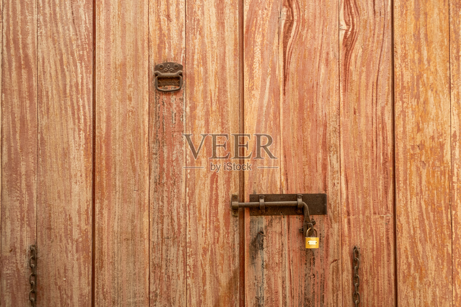 老旧木门的特写，带有金属闩和锁。照片摄影图片