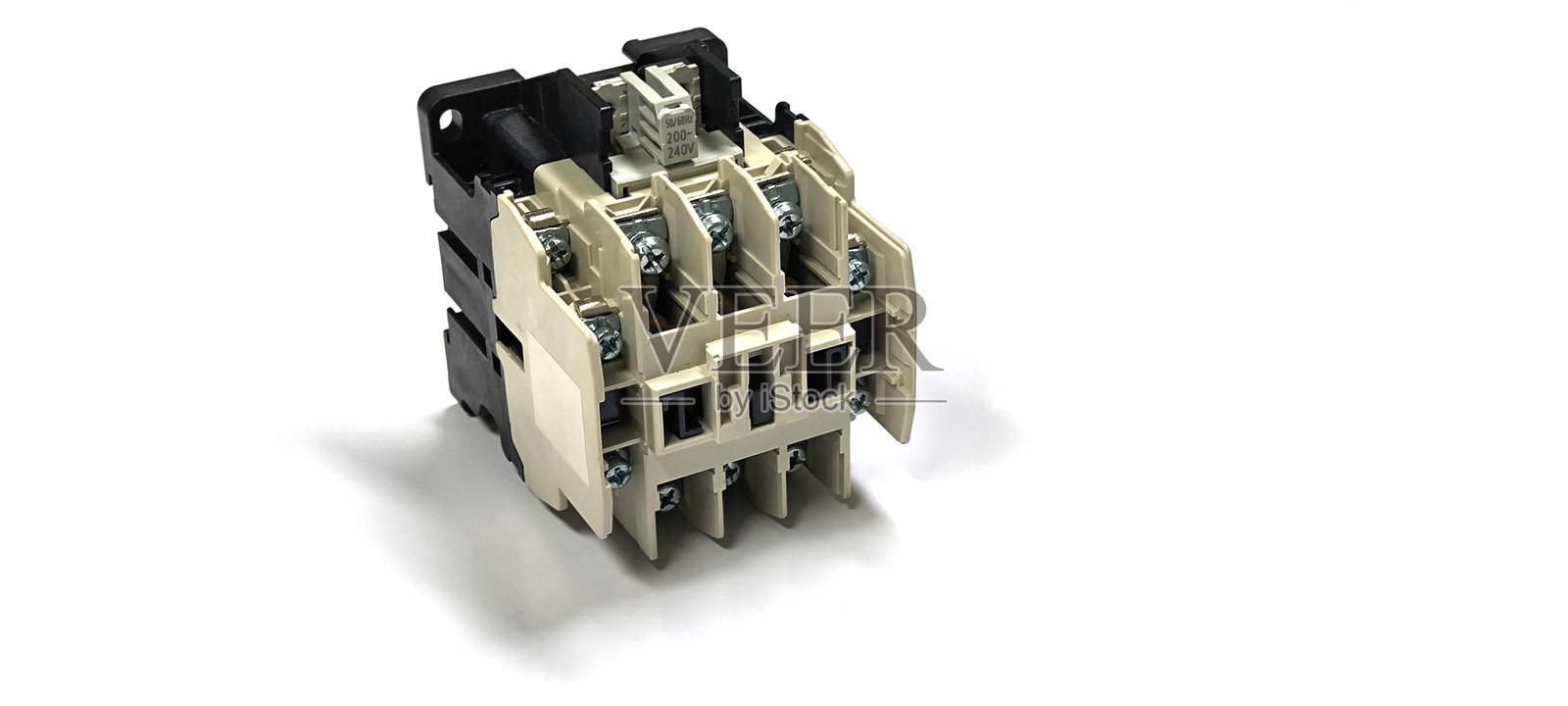 白色背景上的磁性接触器。电气控制设备。照片摄影图片