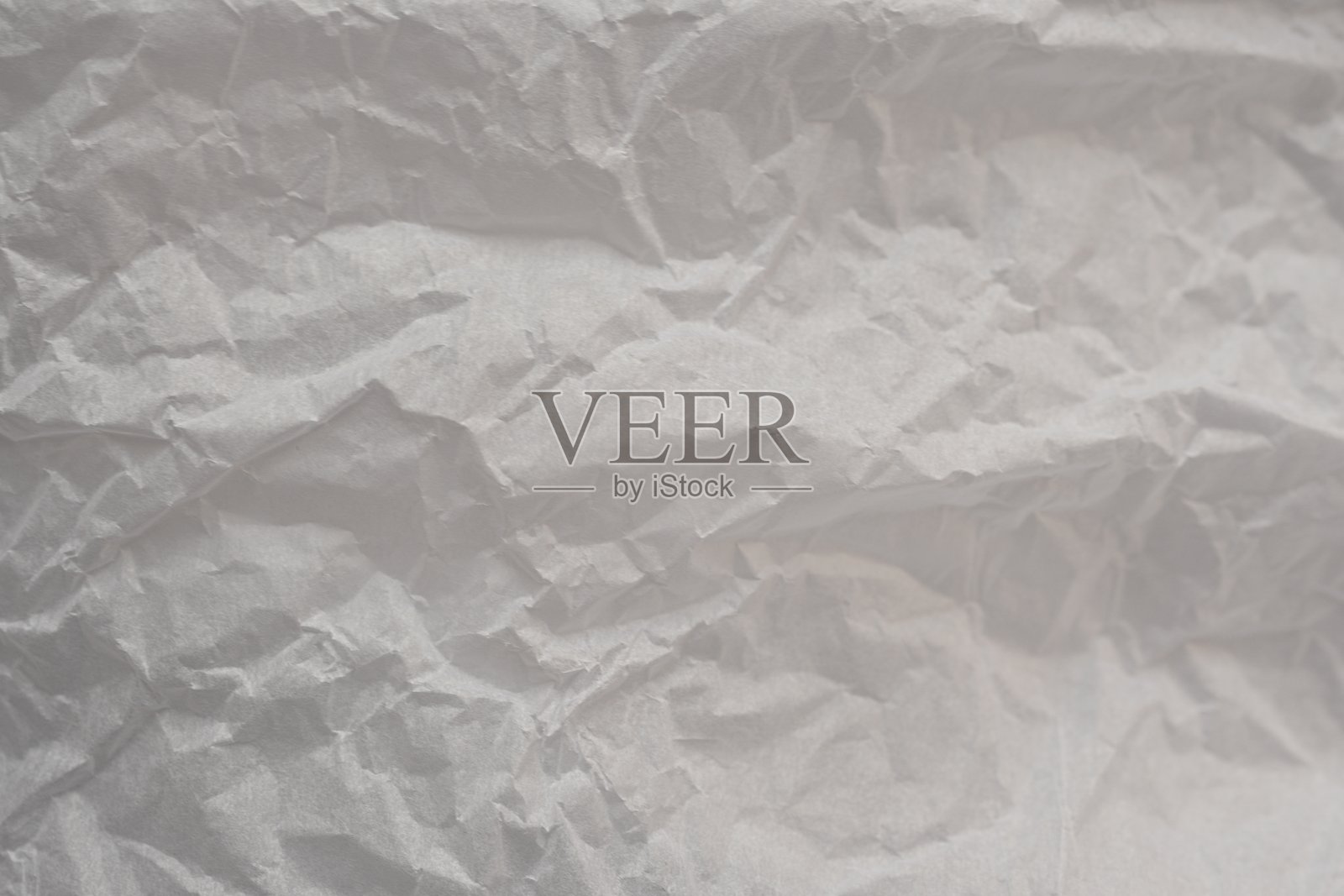 灰色皱纹纸质感作为背景，旧牛皮纸作为背景，皱纹包装材料质感作为背景照片。照片摄影图片