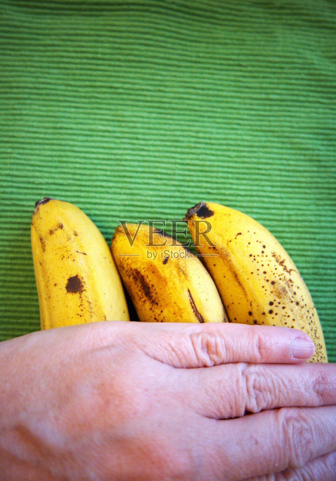 黄色和棕色的香蕉与绿色背景照片摄影图片