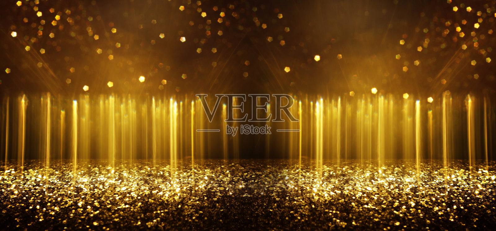 抽象的金色和黑色灯光闪烁背景，虚化效果。照片摄影图片