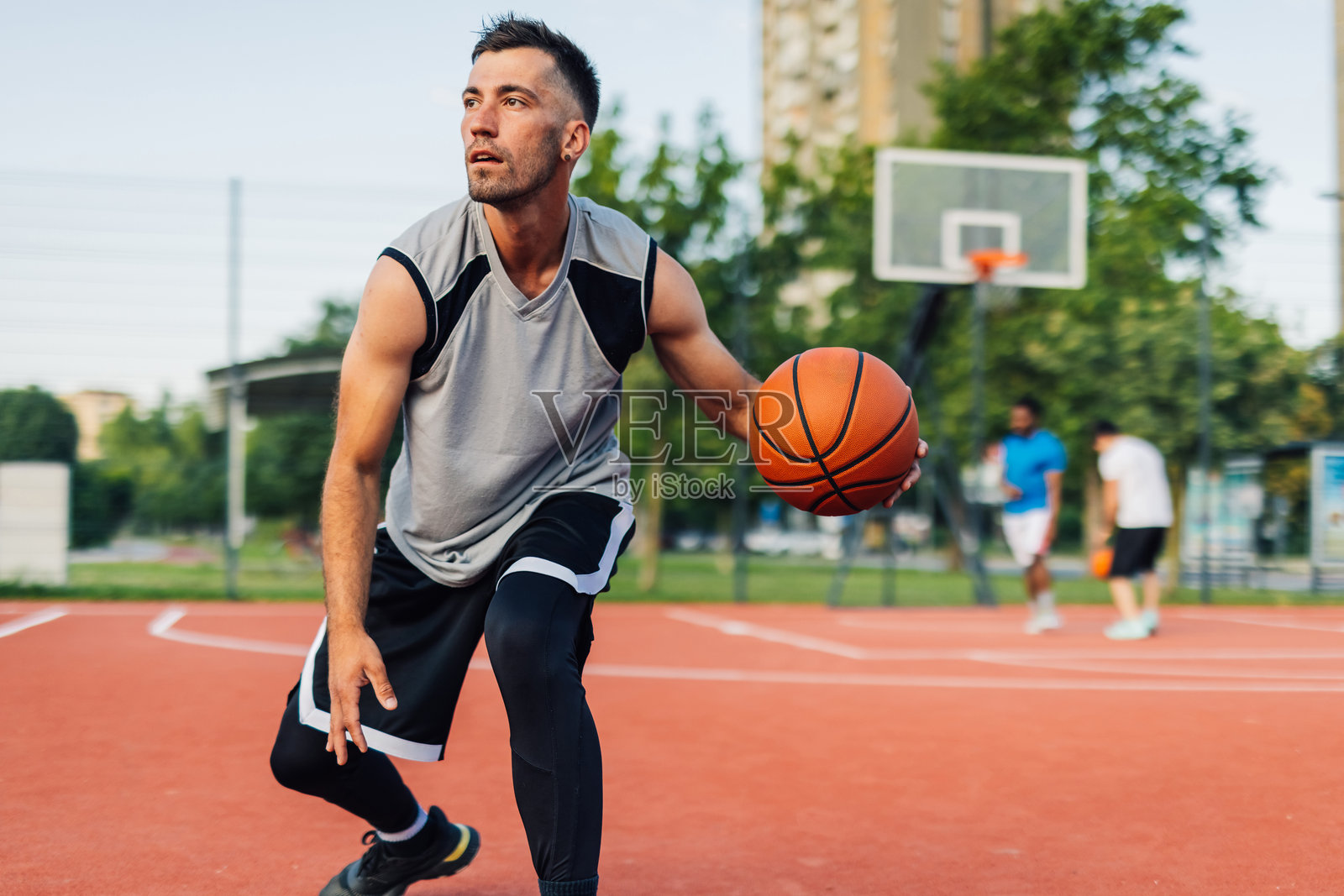 篮球运动员在户外球场运球照片摄影图片