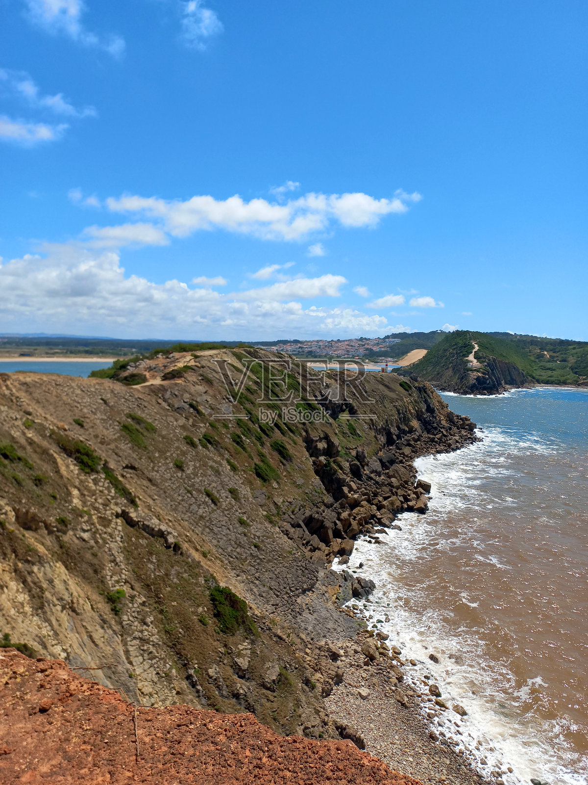 圣马丁纽港崎岖海岸上戏剧性的悬崖和海浪在明亮的夏空下照片摄影图片
