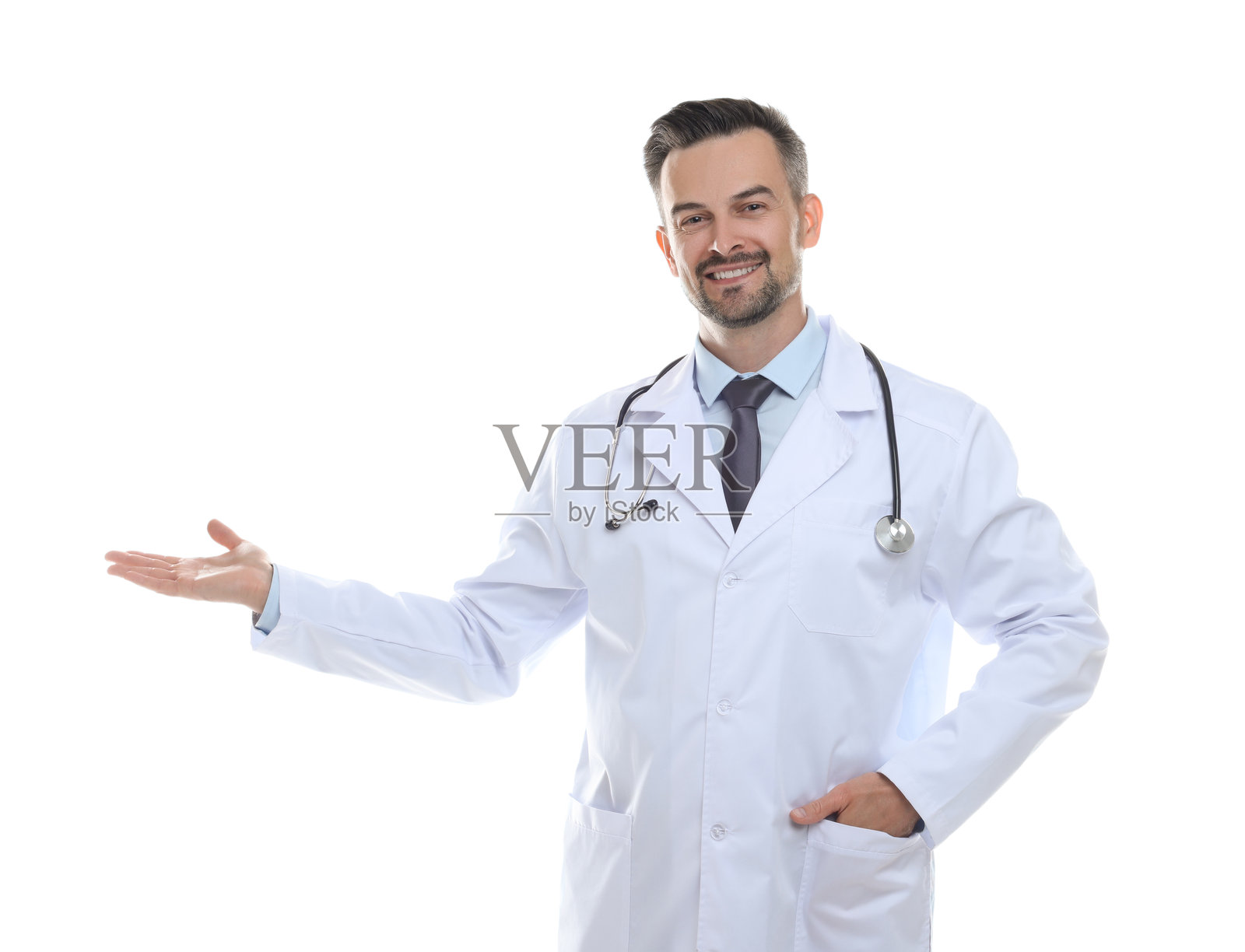 微笑的医生拿着听诊器指向白色背景上的某个东西照片摄影图片