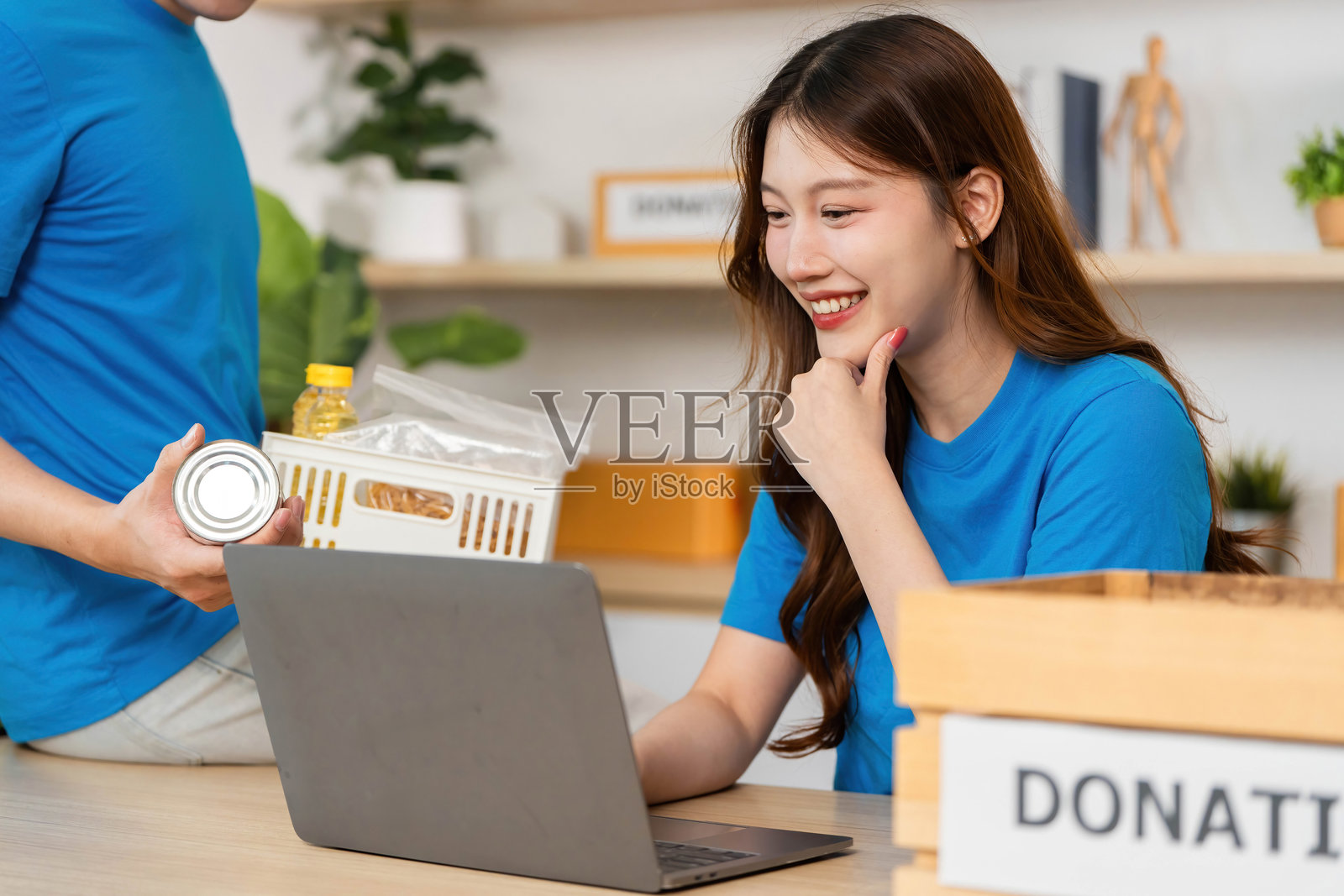 一位女性微笑着接受捐款，支持社区活动。照片摄影图片