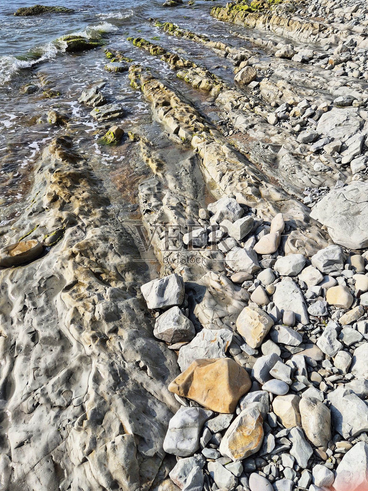 水与岩石海岸相接的地方。一个不寻常的岩石海岸。照片摄影图片