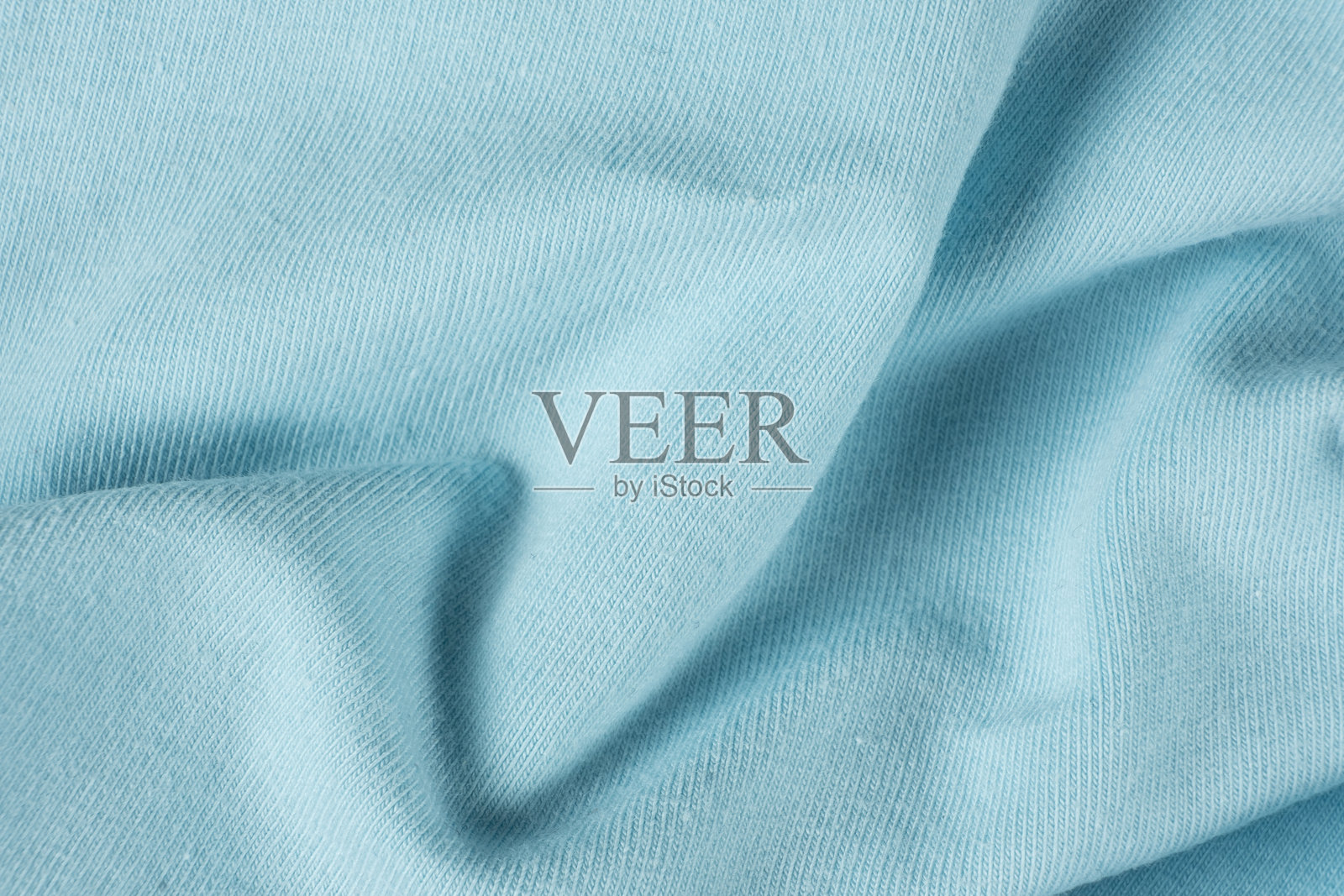 蓝色织物的宏观纹理，由棉花和少量氨纶组成。照片摄影图片