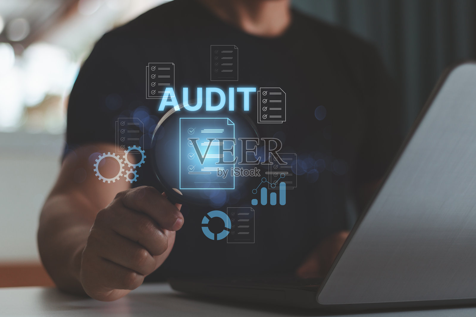 审计商业概念。商人使用笔记本电脑并拿着放大镜检查和评估财务报表，核对组织内的审计清单。照片摄影图片