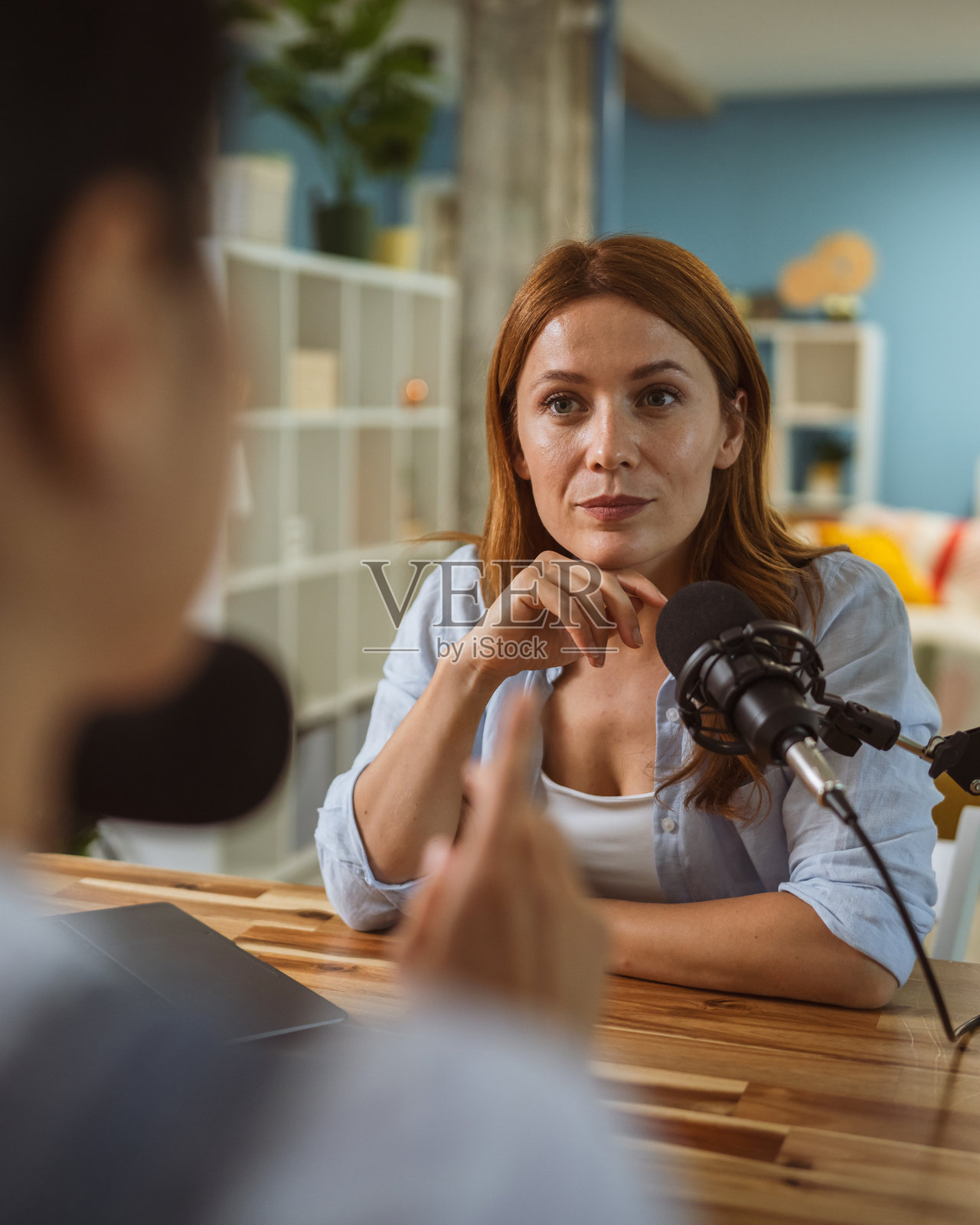 under the shoulder view of female host record podcast at home studio照片摄影图片