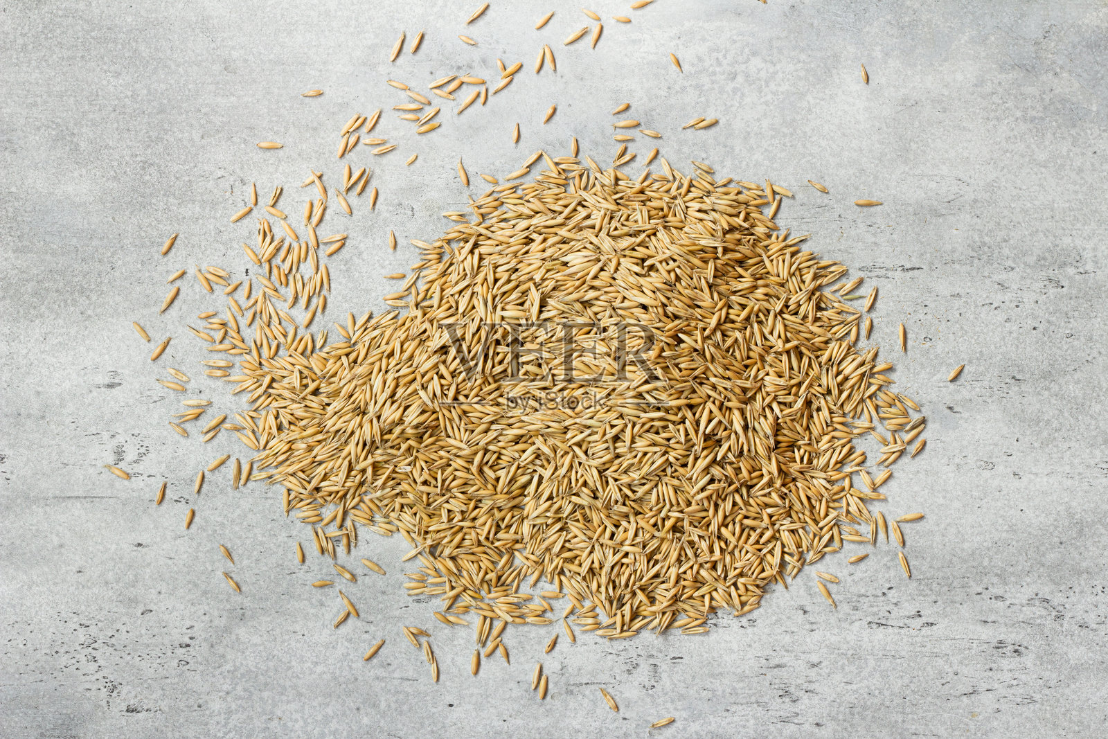 散落在混凝土背景上的生燕麦粒，有机谷物种子，适合健康食品和农业。照片摄影图片