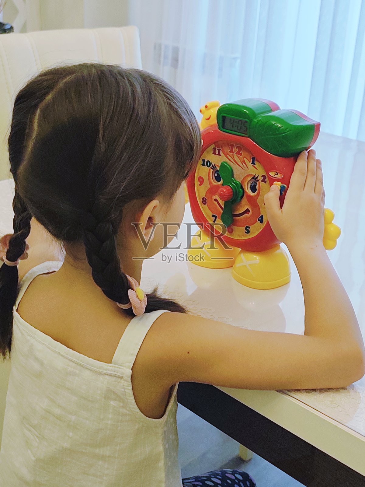 小女孩通过玩具学习时钟照片摄影图片