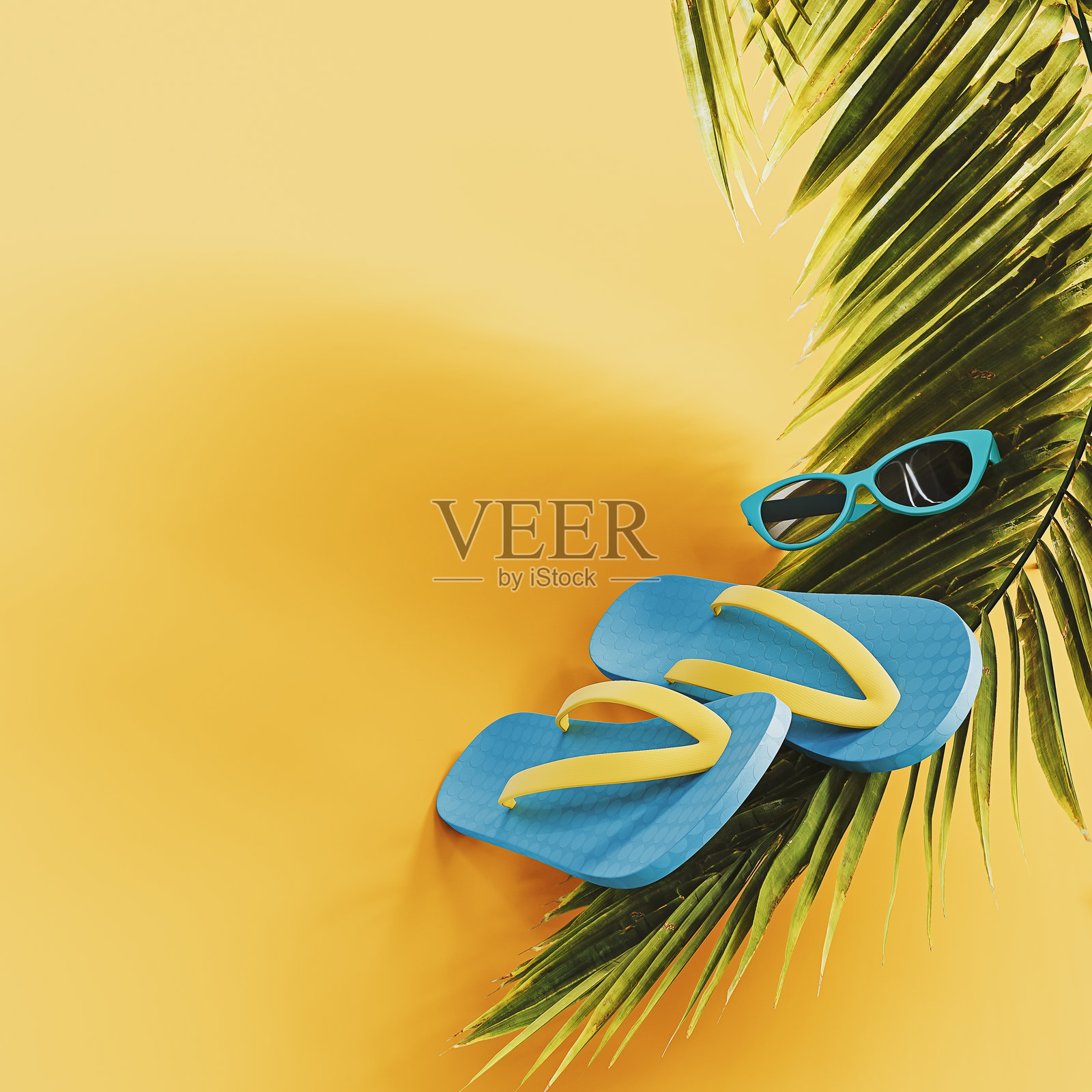 蓝色夏季人字拖和棕榈叶在鲜艳的黄色背景上，留有空白空间。夏季假期概念。照片摄影图片