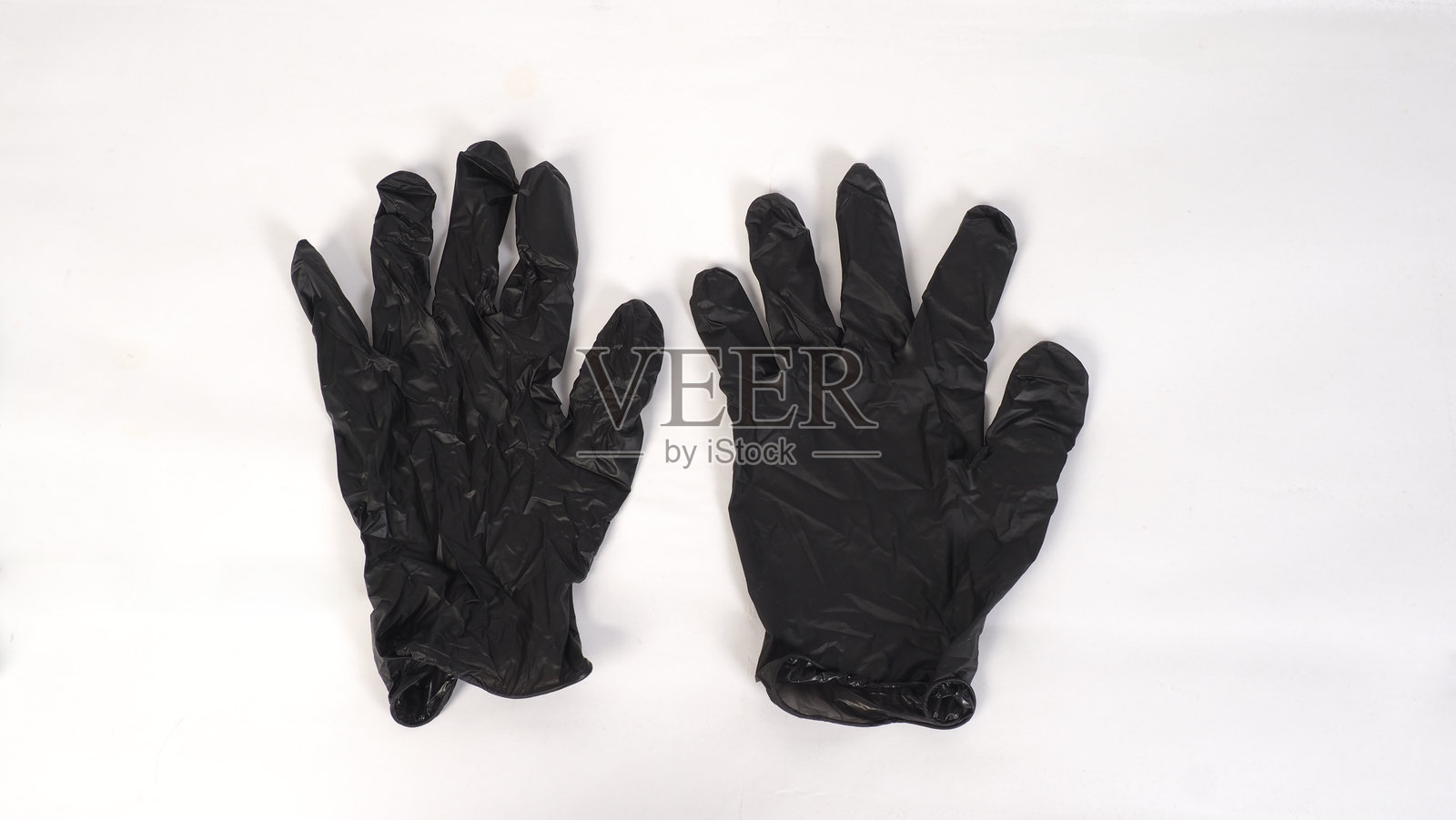 白色背景上的黑色乳胶手套照片摄影图片