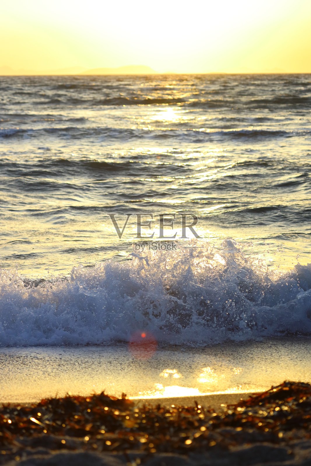 日落时分的海浪溅起特写。阳光下运动的海水。抽象海洋背景照片摄影图片