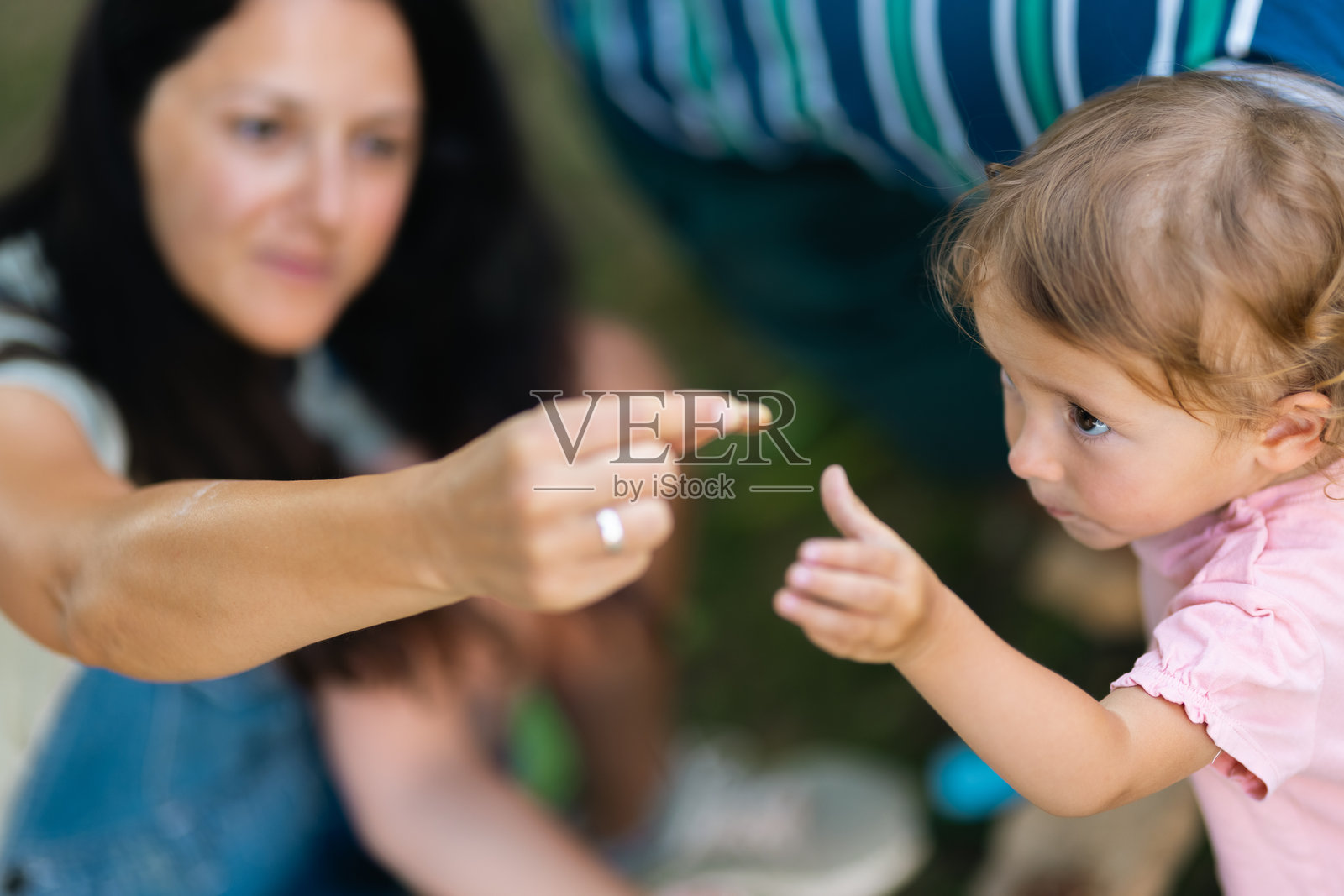 母亲在户外亲密地与孩子互动，共享亲子时光照片摄影图片