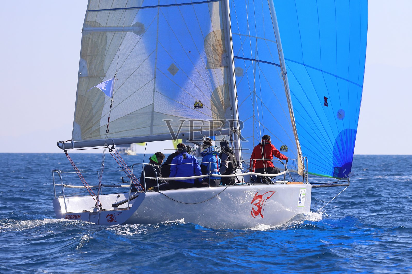 帆船在爱琴海的蓝色海水中迎风航行,靠近著名度假胜地博德鲁姆的海岸。照片摄影图片