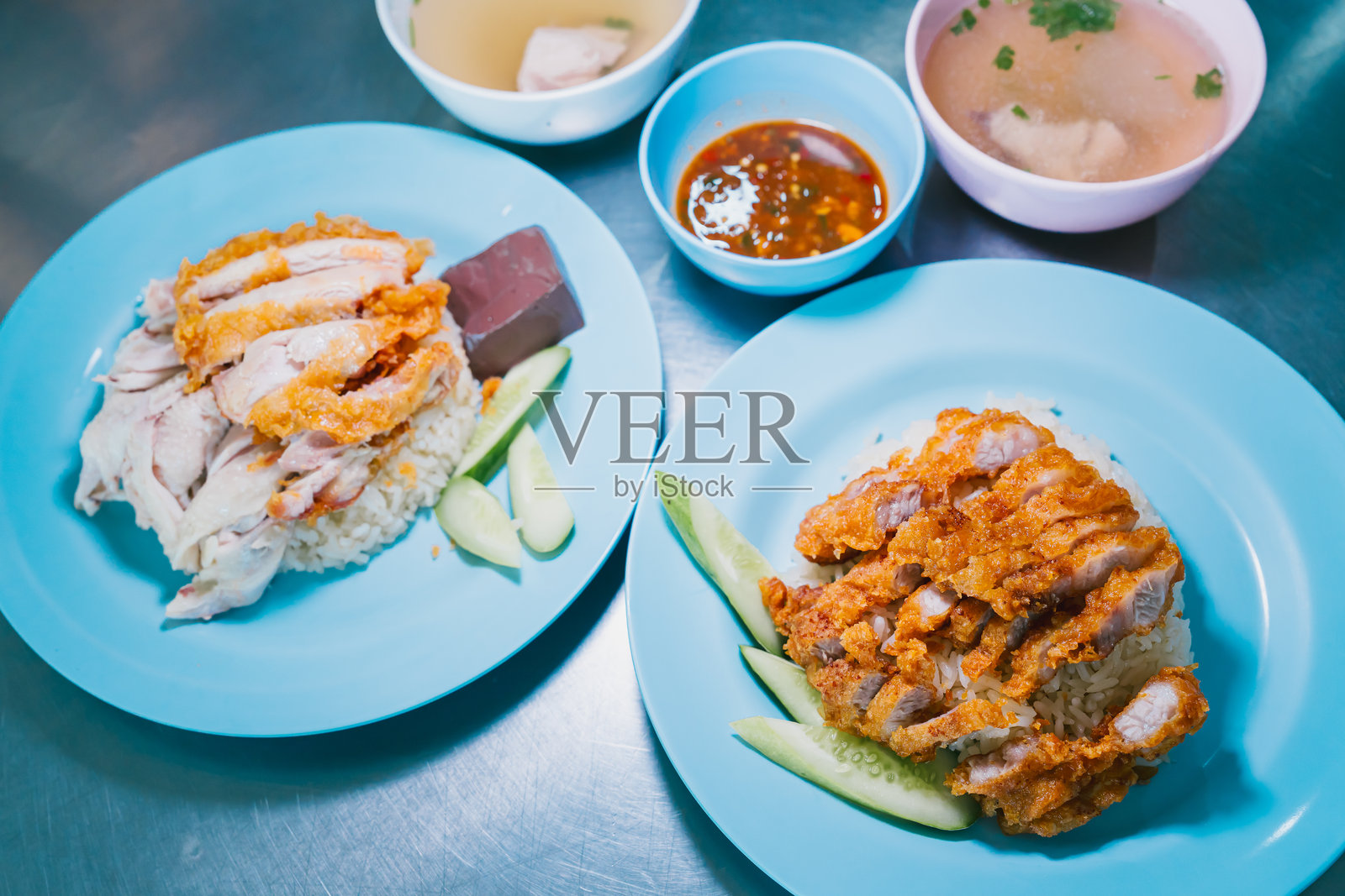 美味的海南鸡饭，搭配脆皮鸡和汤，摆放在餐桌上照片摄影图片