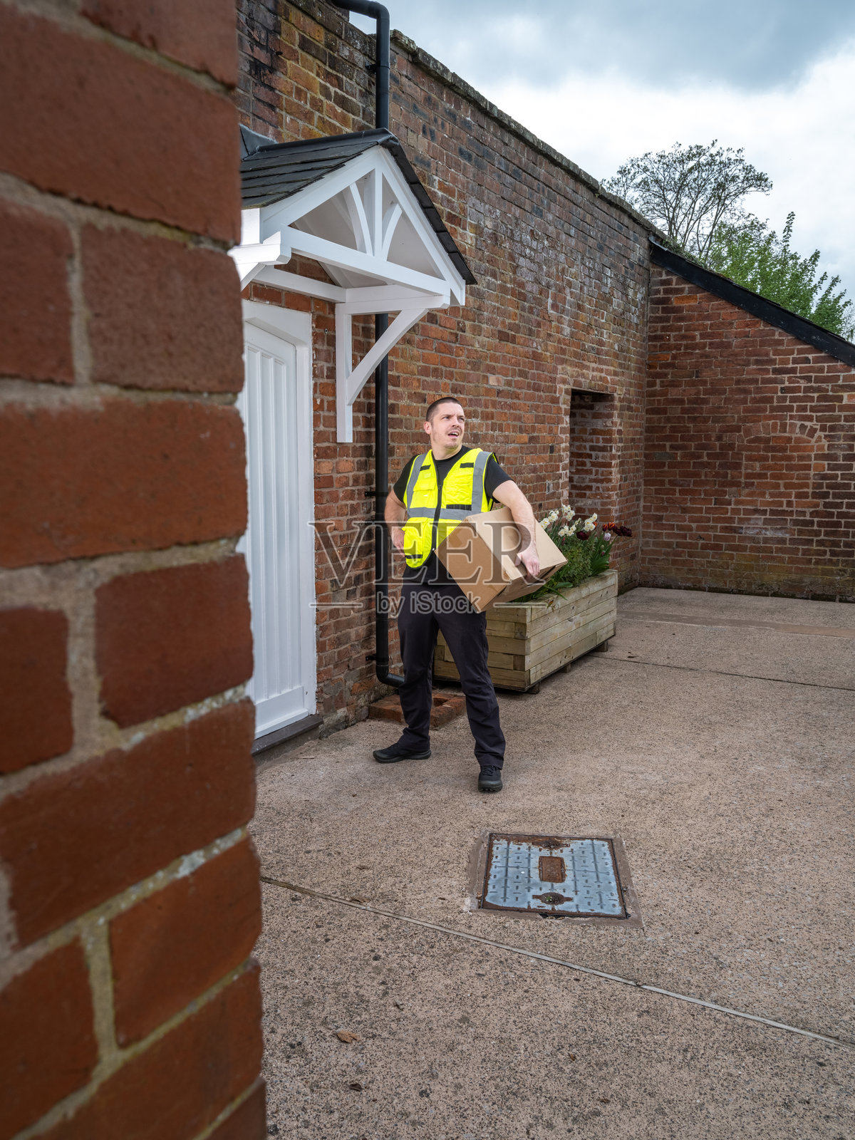 快递员在乡村房屋前等待照片摄影图片
