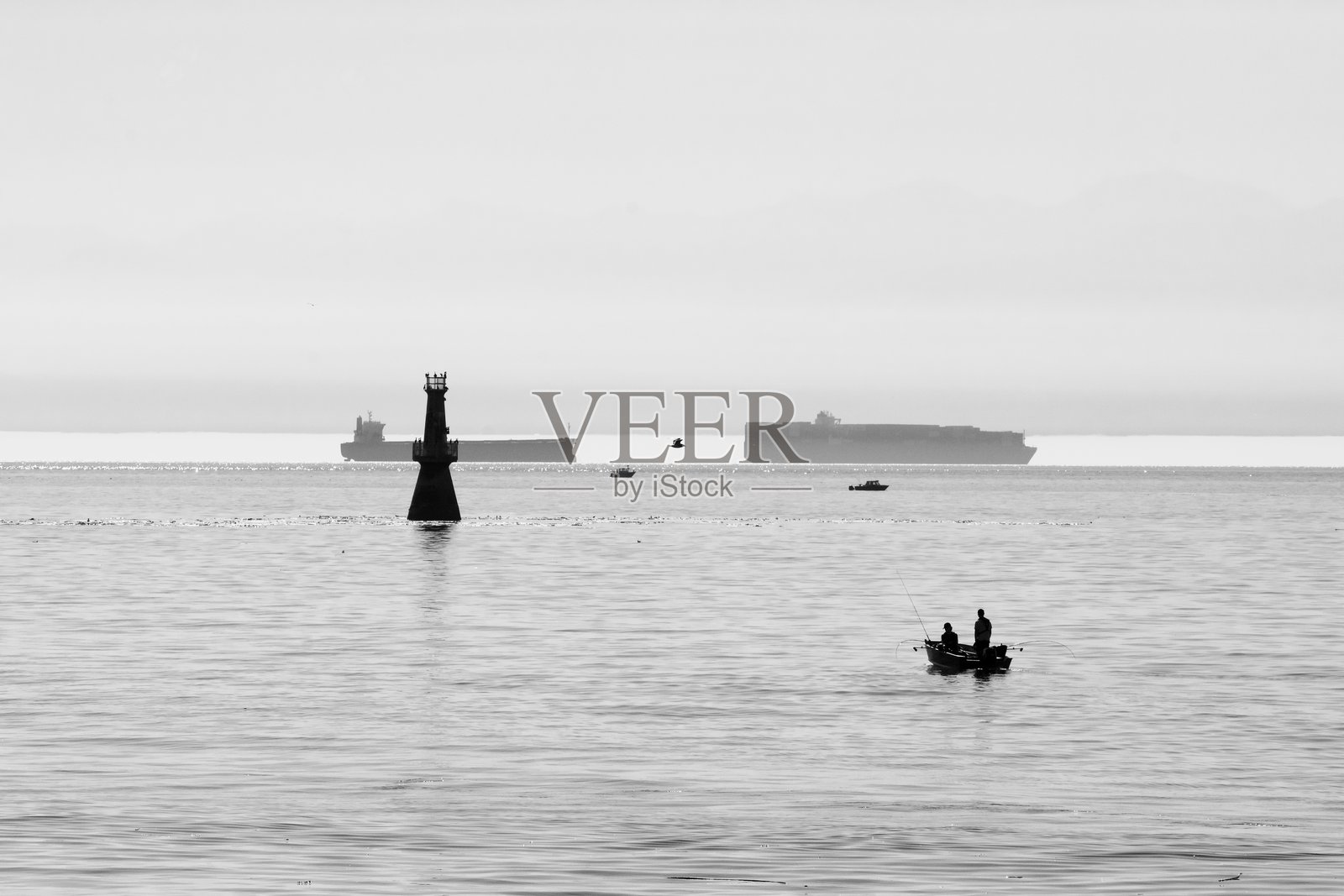 从奥格登角防波堤俯瞰胡安·德·富卡海峡，展现了运动钓鱼船、货船和导航设备。照片摄影图片