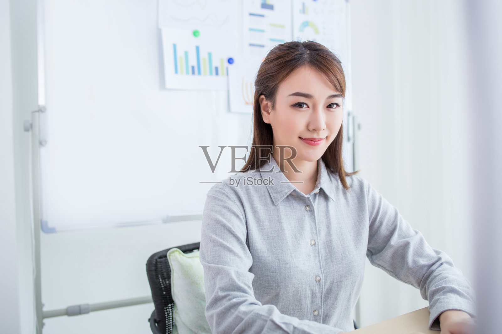 自信的亚洲女商人在办公桌前照片摄影图片