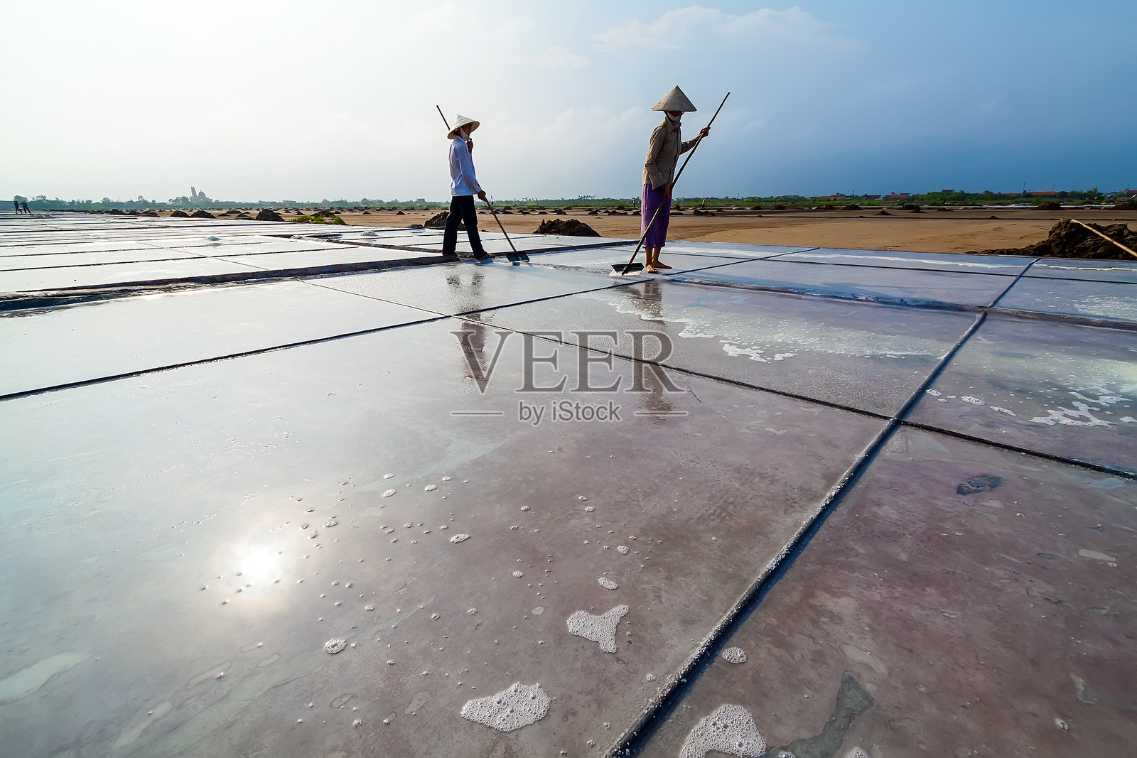 盐工在盐田工作照片摄影图片