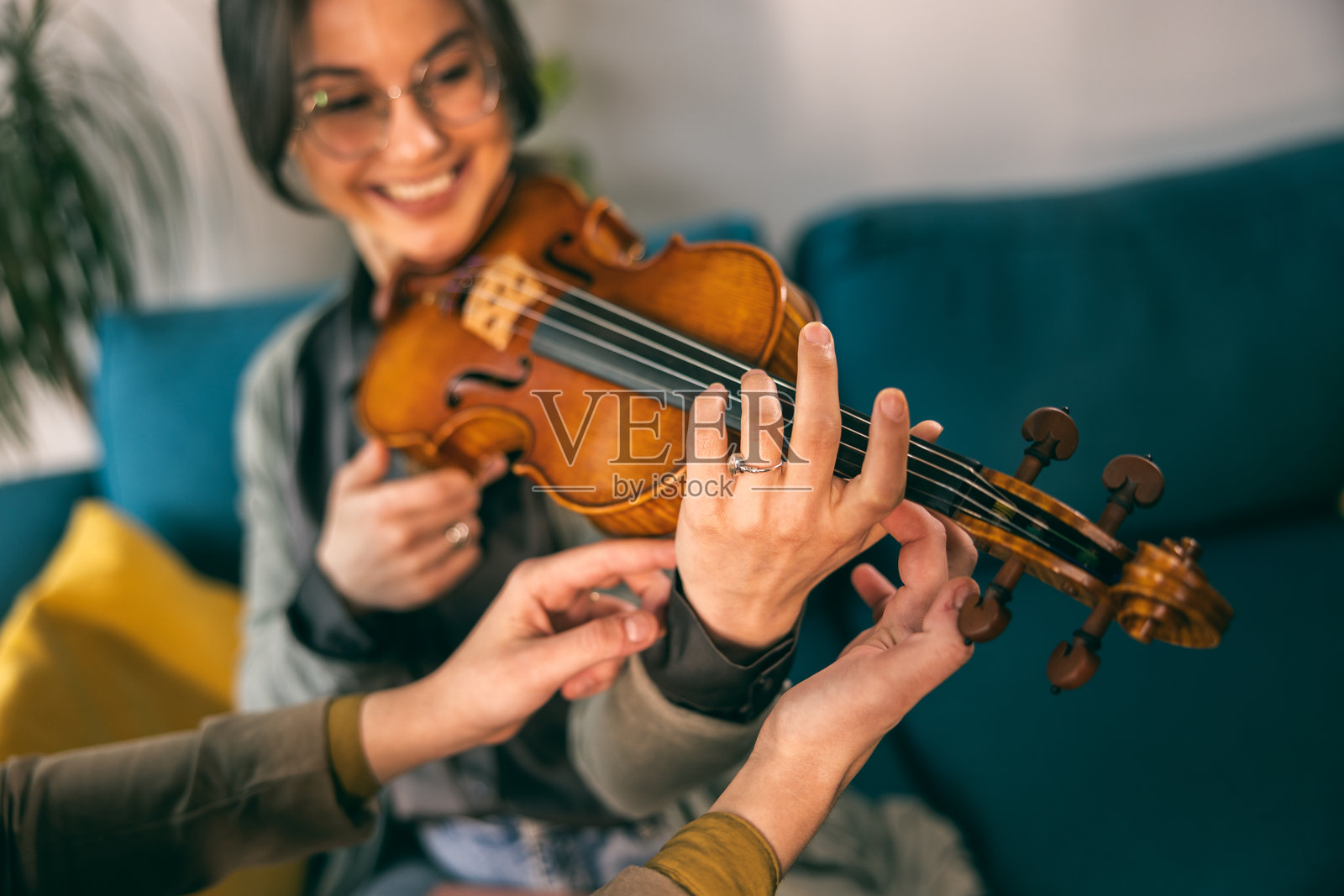 音乐老师教学生如何握住小提琴照片摄影图片