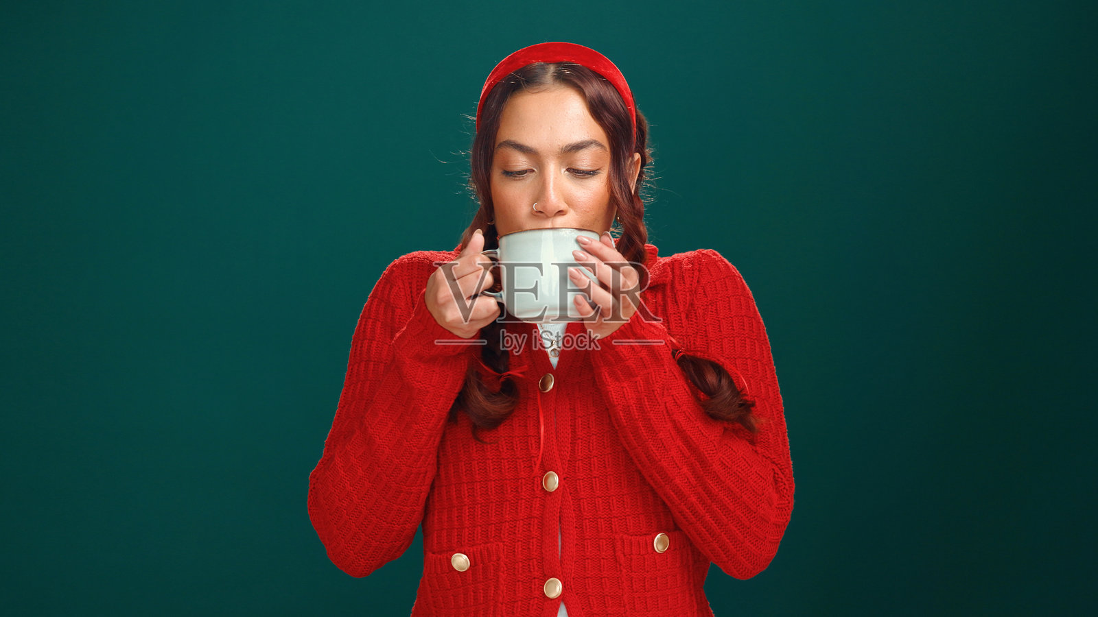 工作室，女人在喝热巧克力，适合圣诞节和冬季饮品，十二月或假日。绿色背景，享受温暖的可可，节日季节或庆祝活动，圣诞摩卡。照片摄影图片