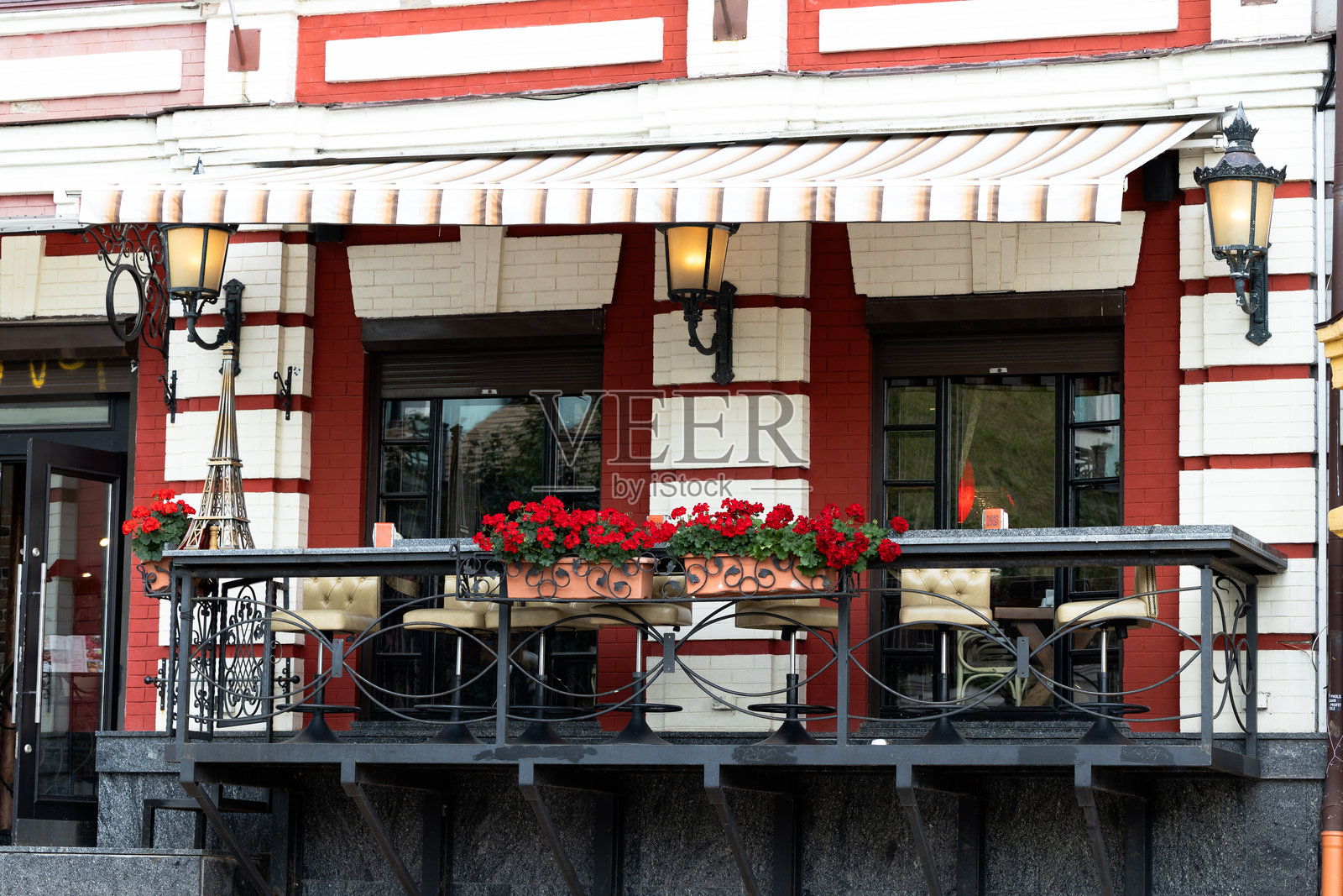 浪漫的阳台餐厅户外用餐区，装饰有灯笼、花盆和家具物品。照片摄影图片