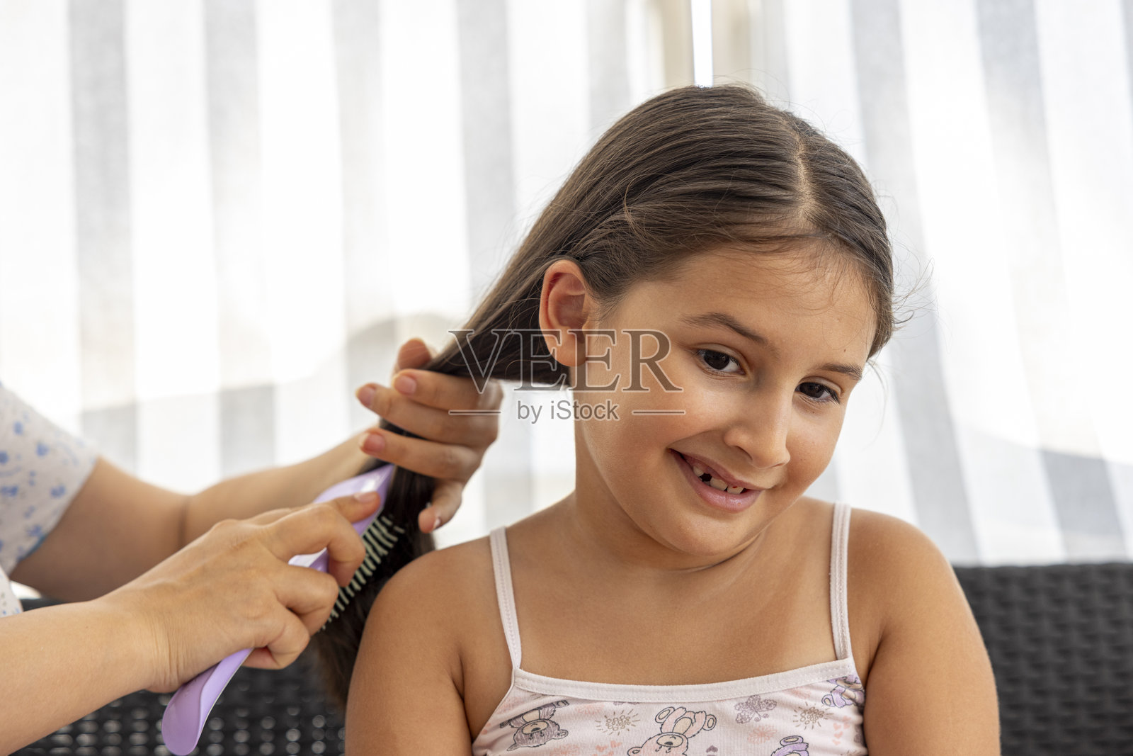 小女孩在妈妈的梳理下，展现出各种面部表情照片摄影图片