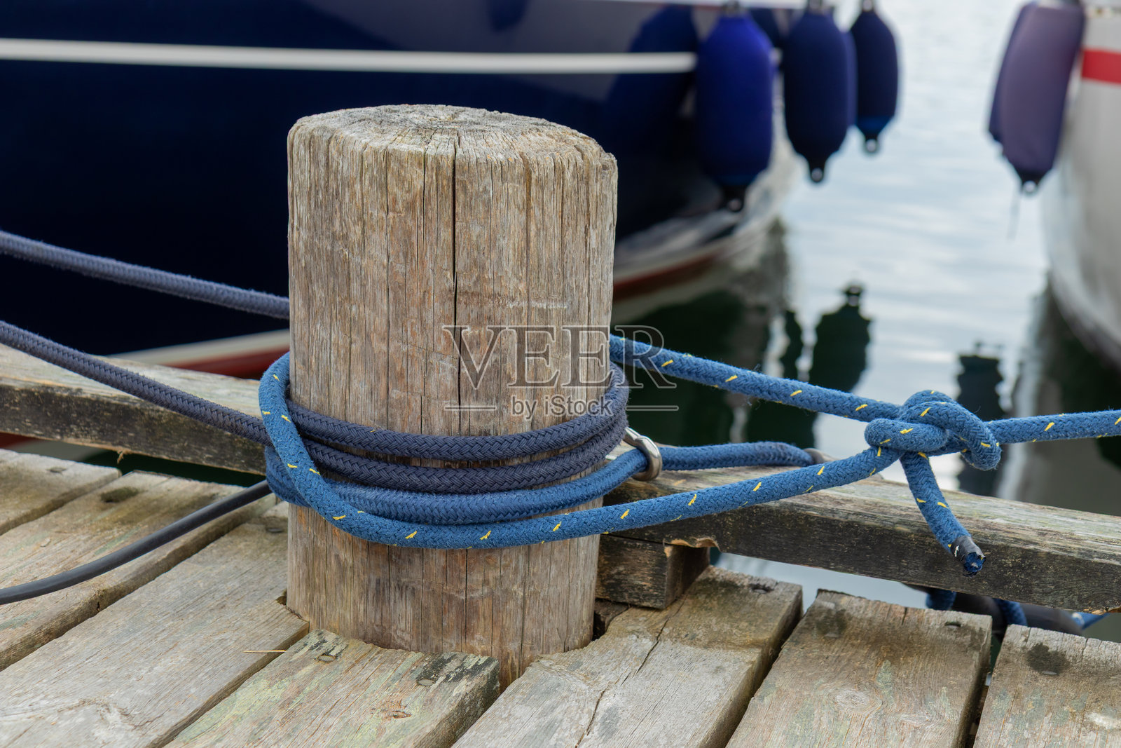 系船绳特写，稳固地将船只固定在码头上。海洋细节象征着安全、航海技艺以及海洋旅行和与海洋连接的永恒传统。照片摄影图片