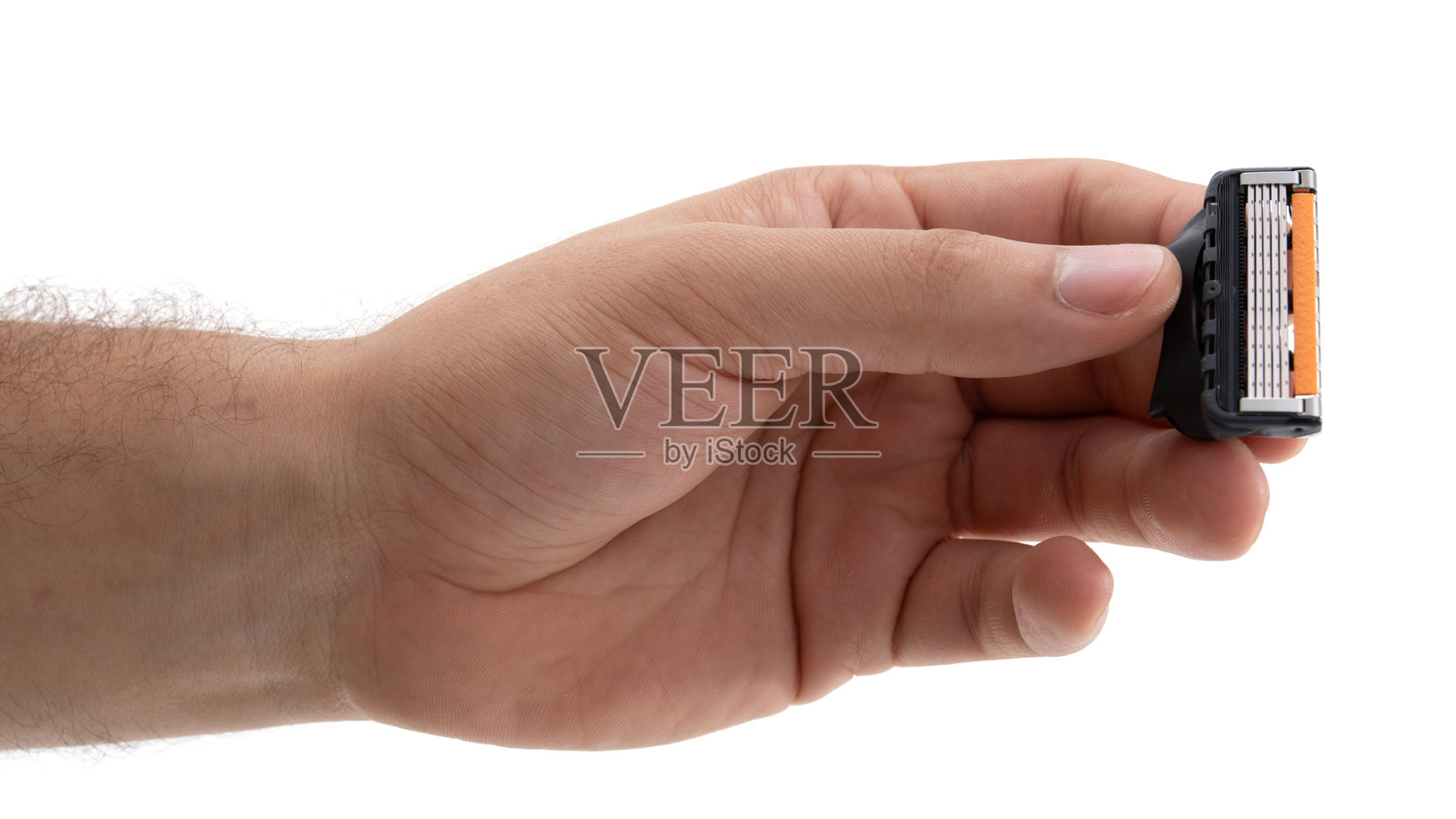 手握剃须刀刀头，展示日常护理和个人护理工具的必需品照片摄影图片