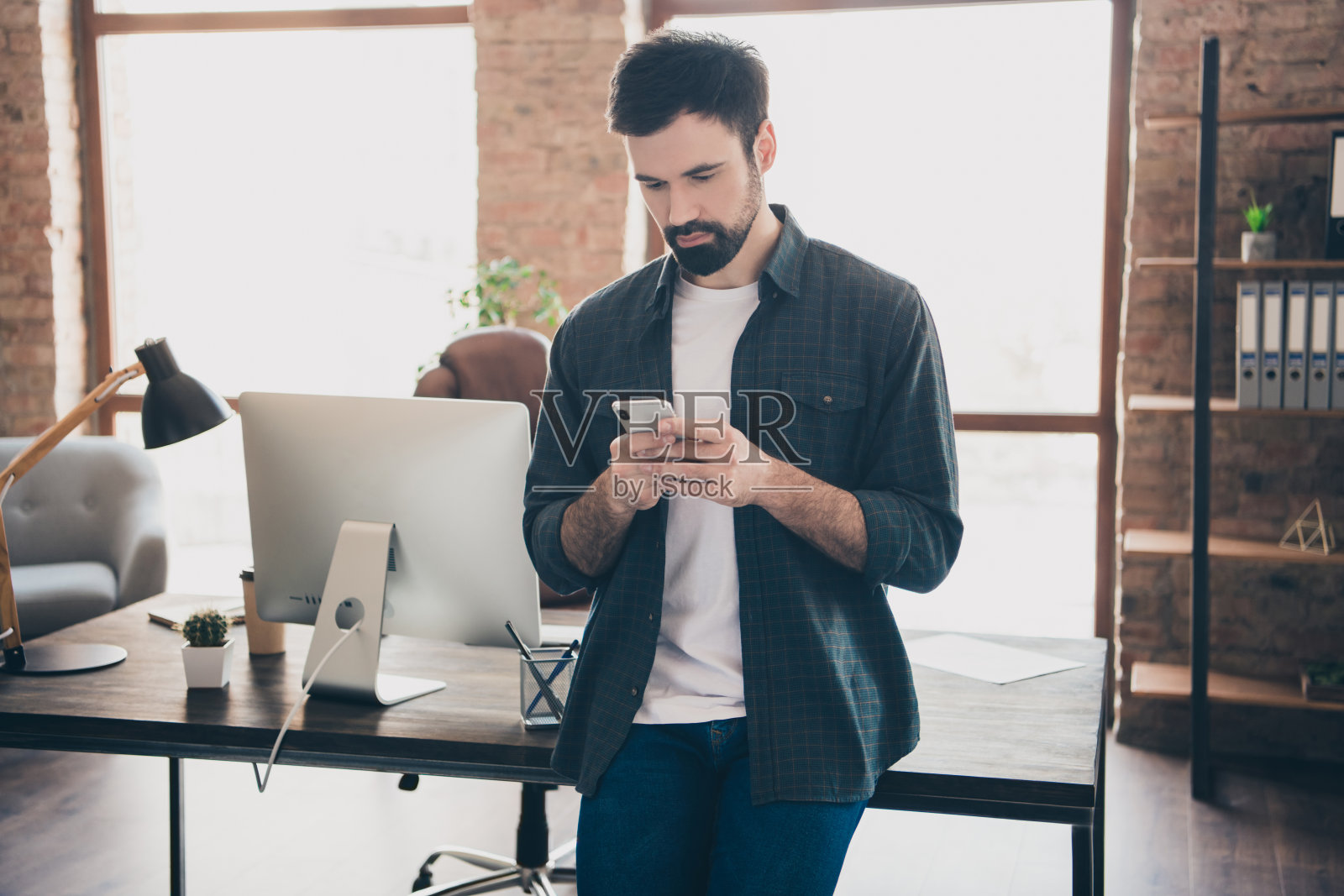 年轻企业家在手机上浏览互联网并打字的照片肖像照片摄影图片