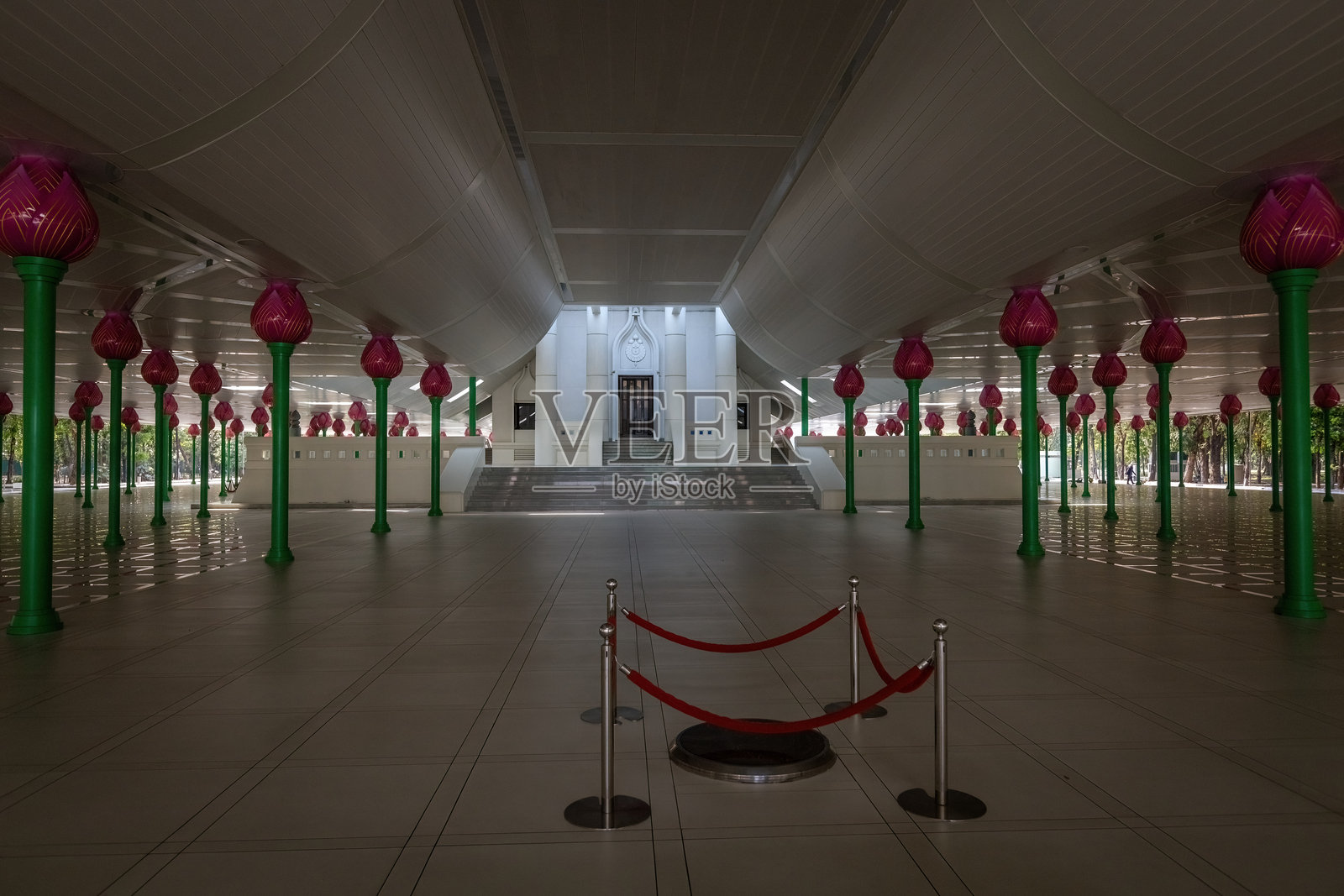 泰国法身寺的内部景观，展示了莲花形柱子和现代佛教寺庙建筑群内的纪念墙。照片摄影图片