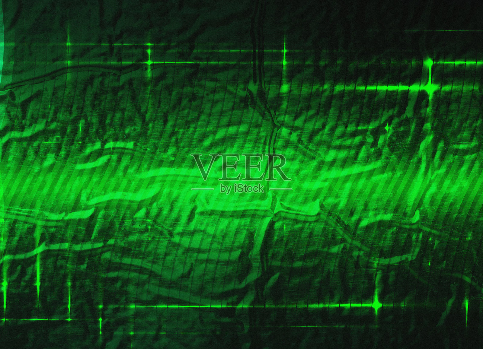 带有绿色光照的纹理表面。光的水平和垂直线条叠加在材料上。照片摄影图片