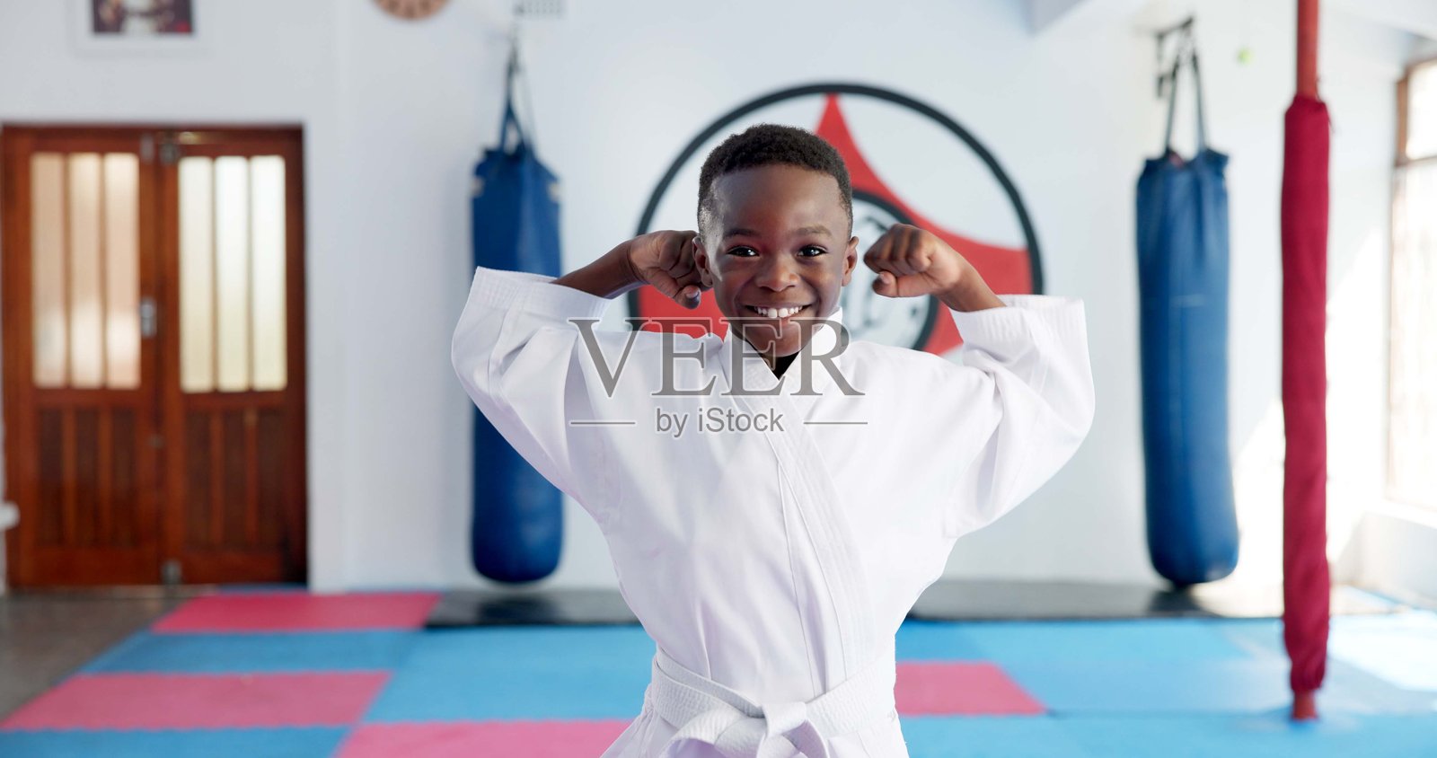 在道场中灵活的男孩学生的武术、空手道肖像，适合战斗、武术或体育训练。快乐的非洲孩子在健身房中锻炼，展现自信，促进教育、发展或成长。照片摄影图片