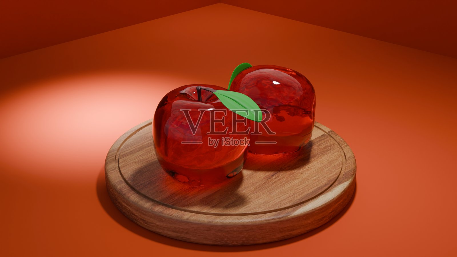 两个玻璃苹果放在木板上，背景是温暖的红橙色。照片摄影图片